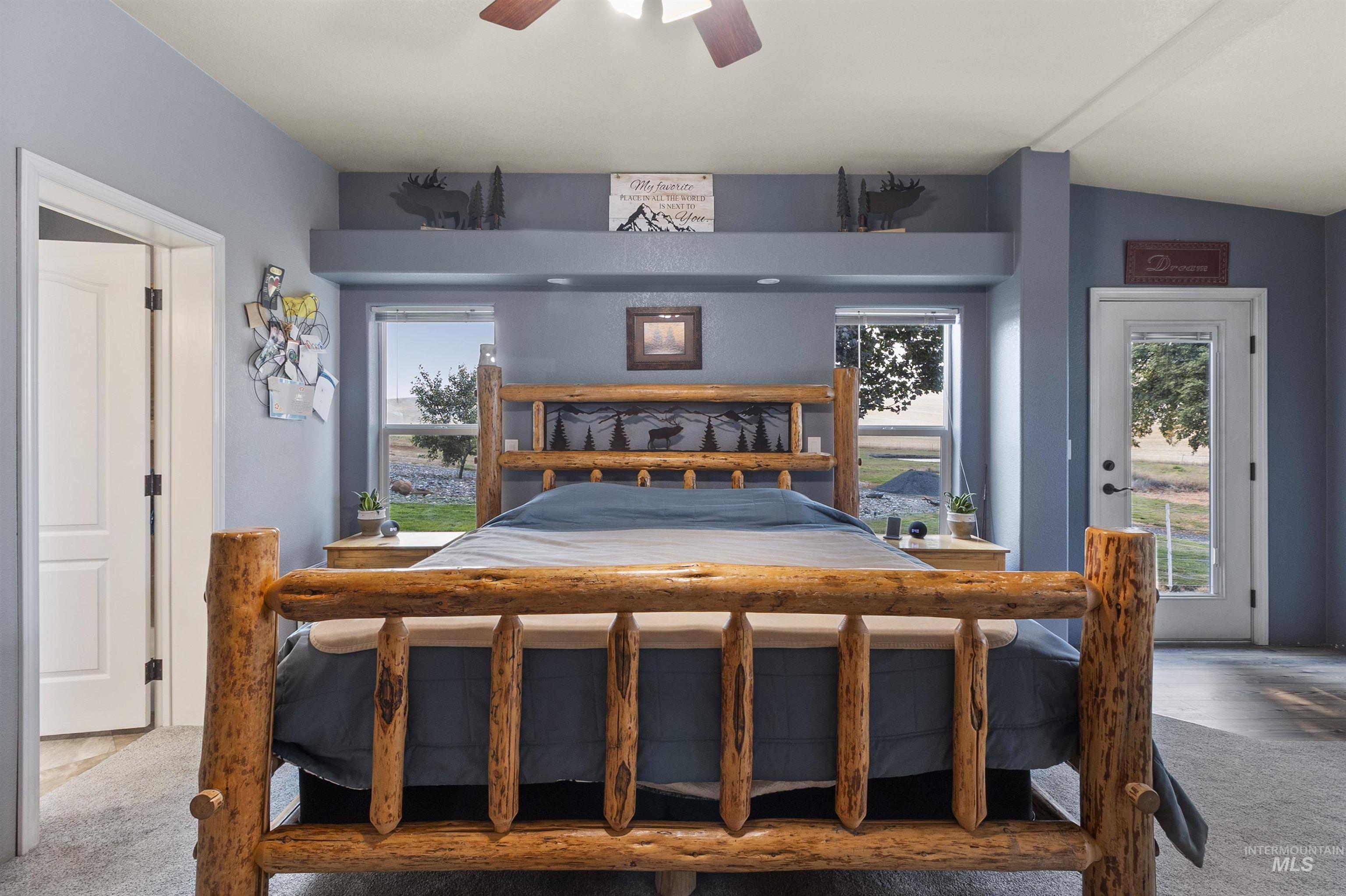 Carpeted bedroom with access to outside and ceiling fan