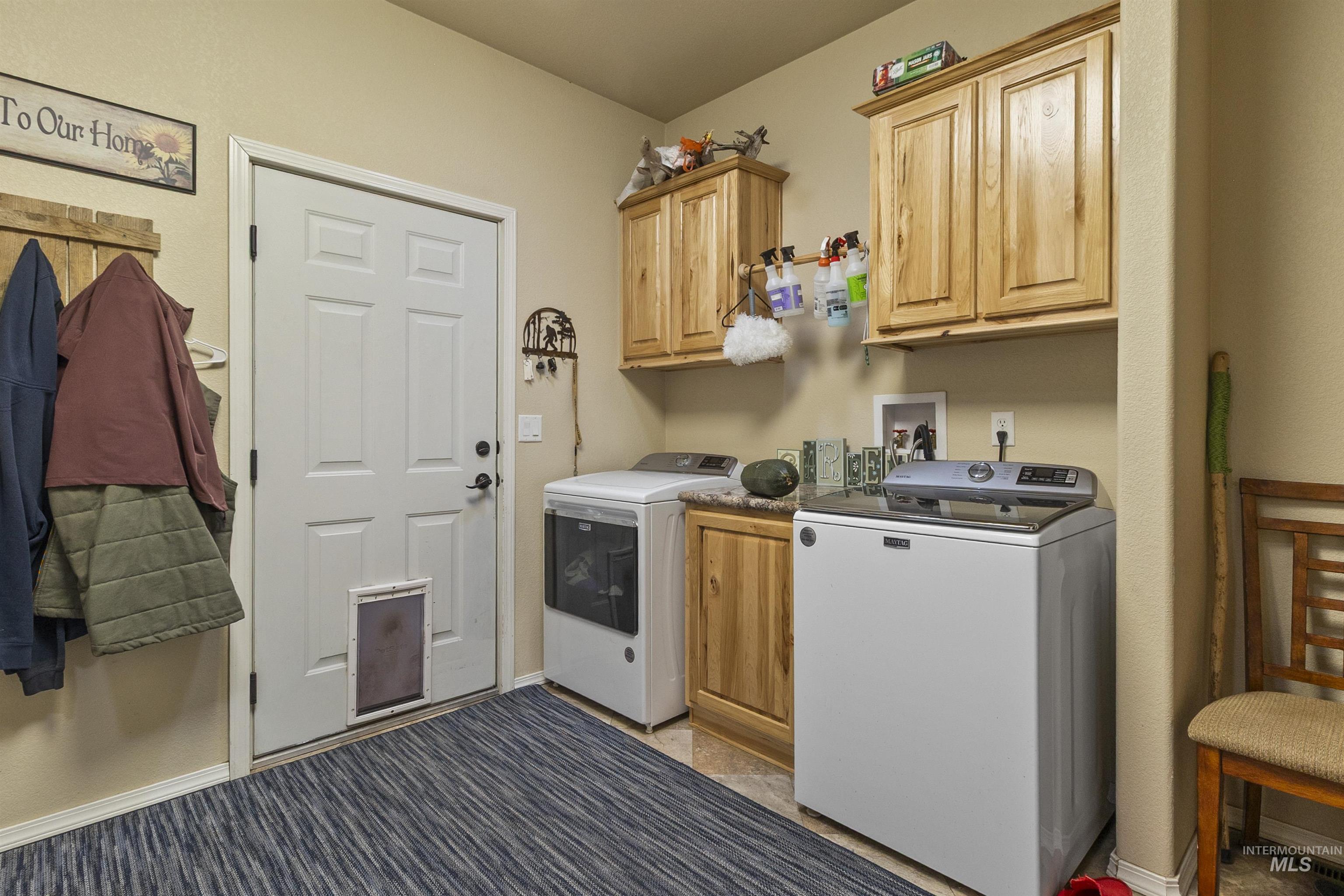 Laundry area featuring cabinet space and washer and clothes dryer