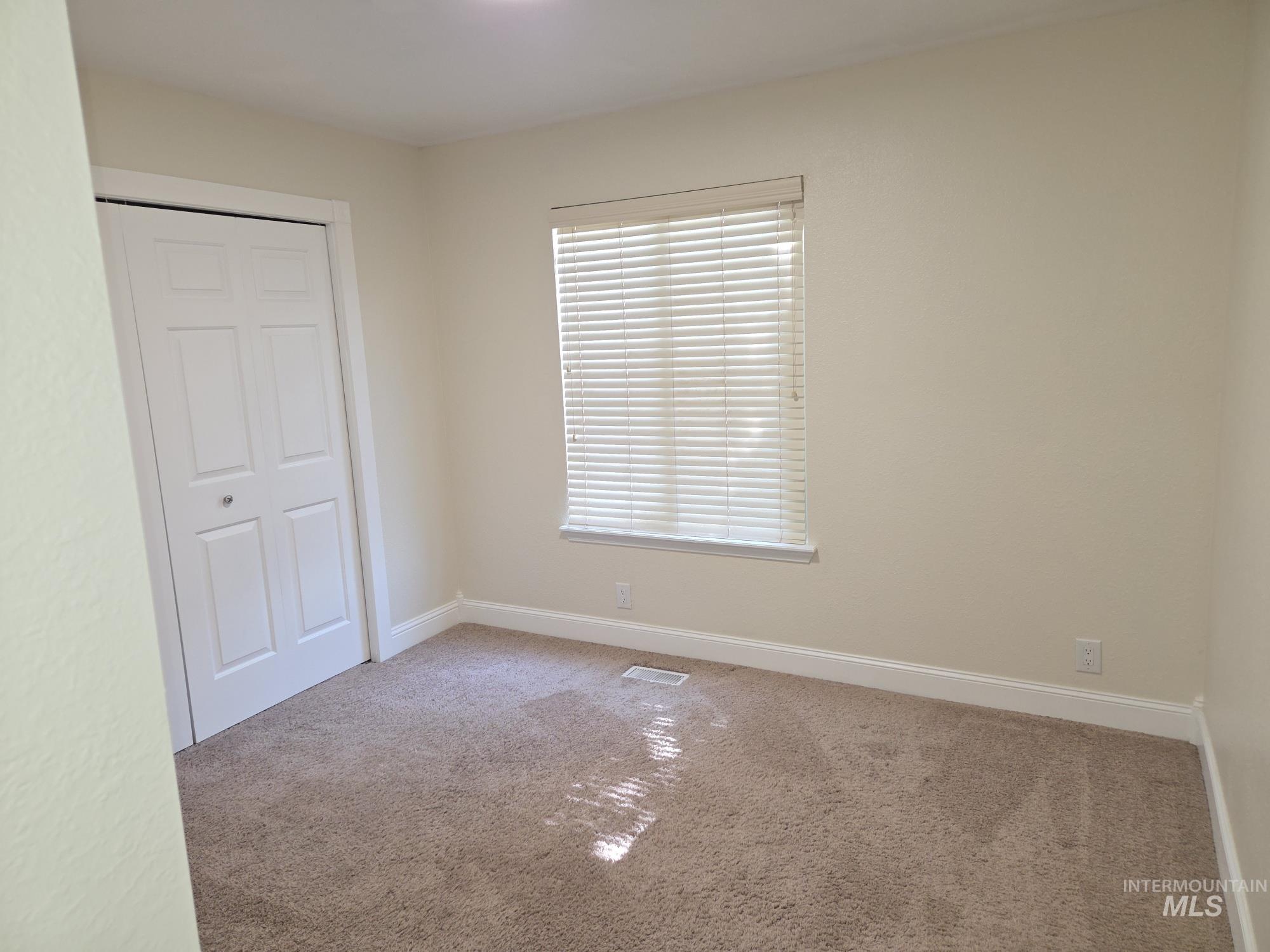 Unfurnished bedroom with carpet flooring and a closet