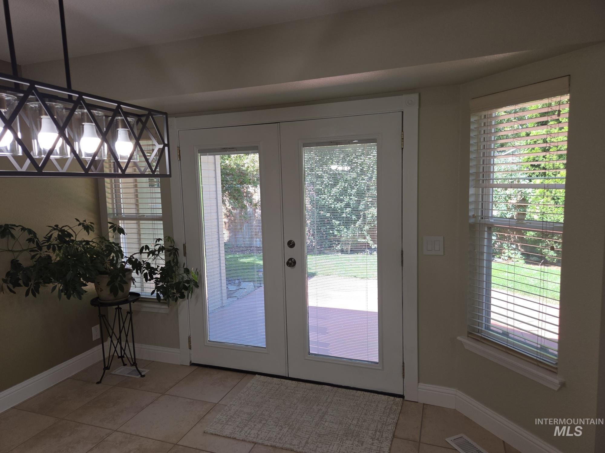 Doorway featuring french doors and tile patterned flooring
