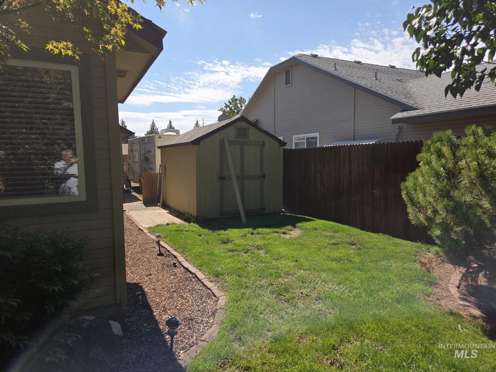 View of yard with a storage shed