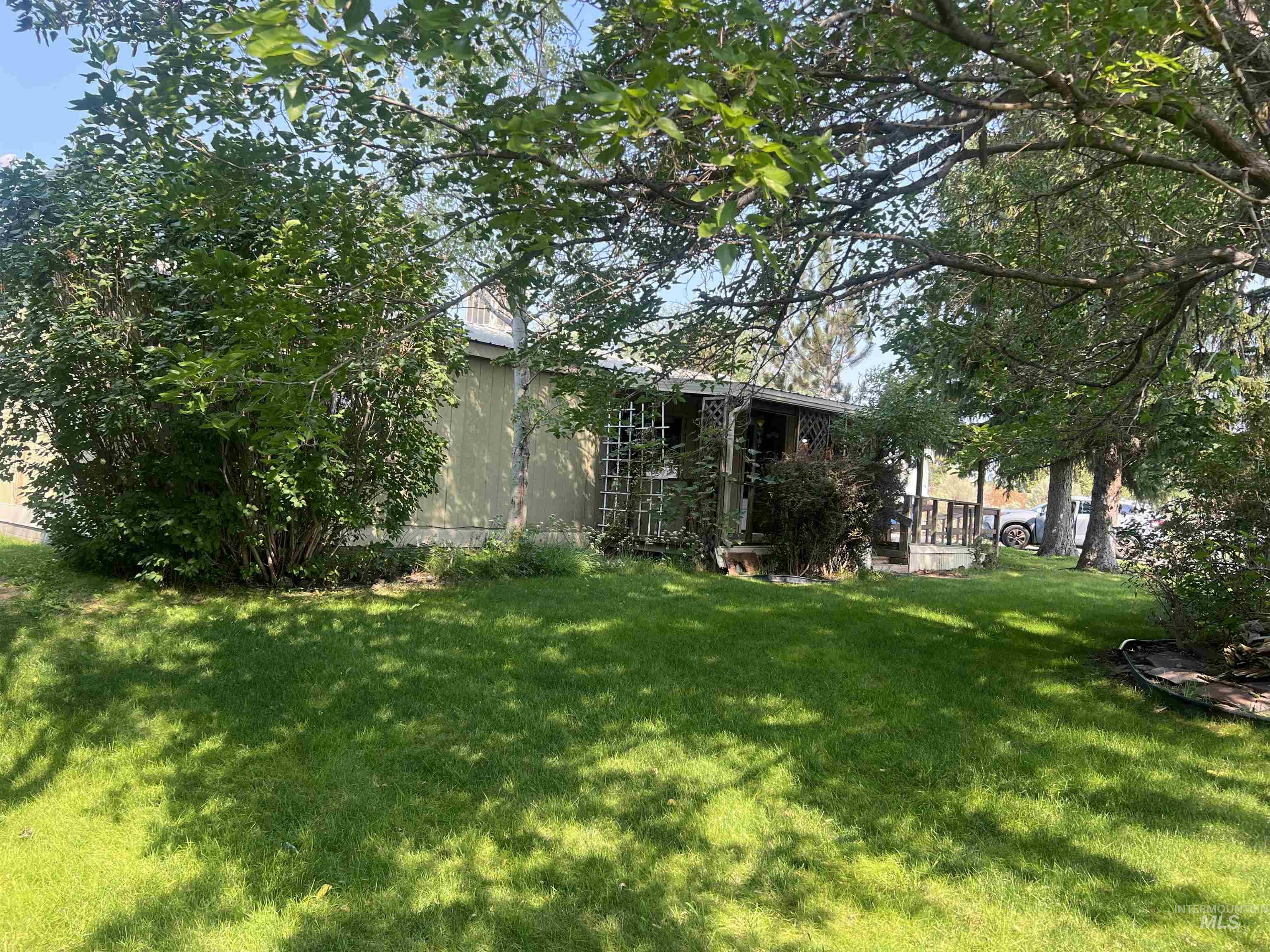 View of grassy yard with a deck