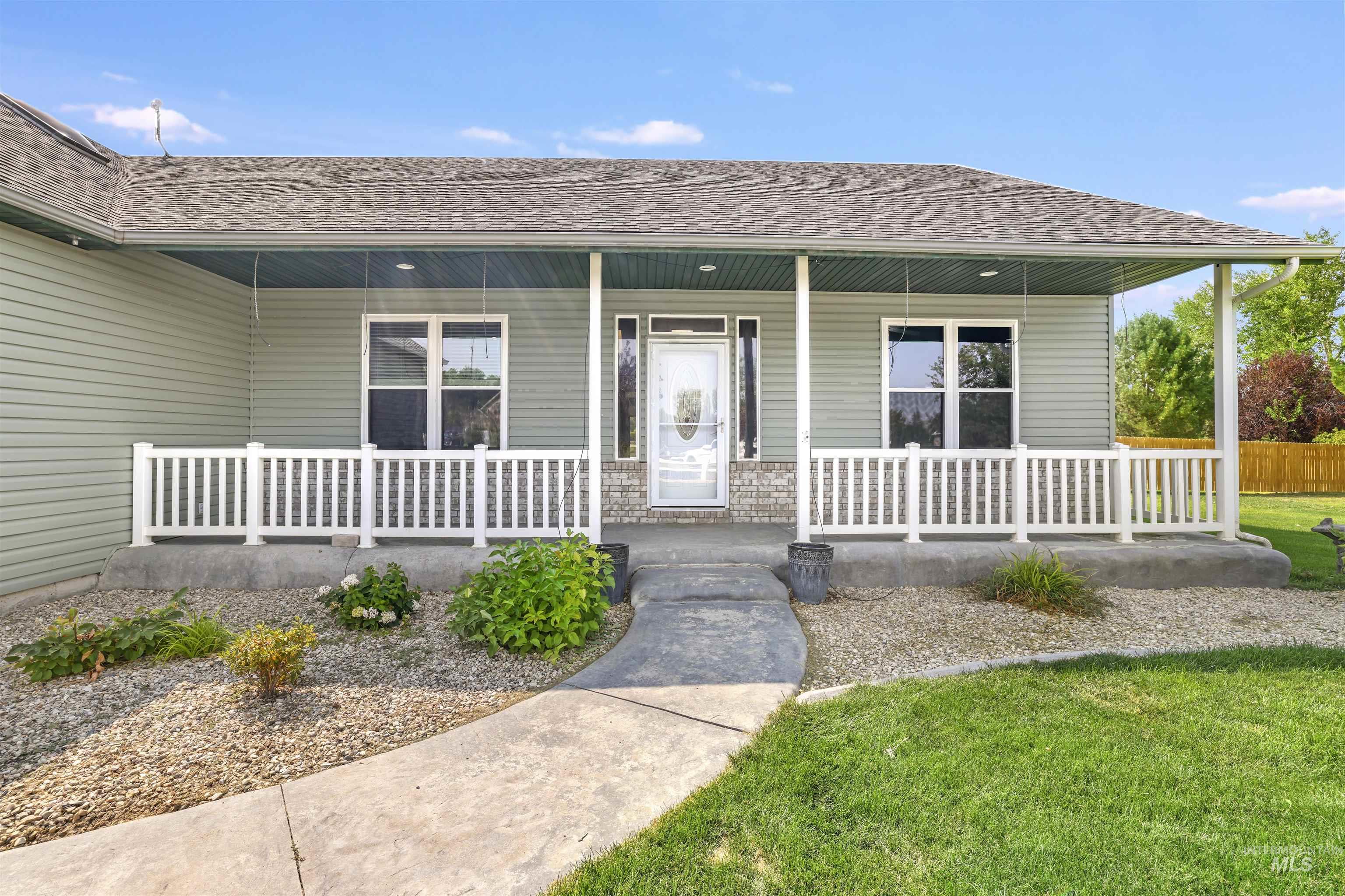 Property entrance with roof with shingles and covered porch