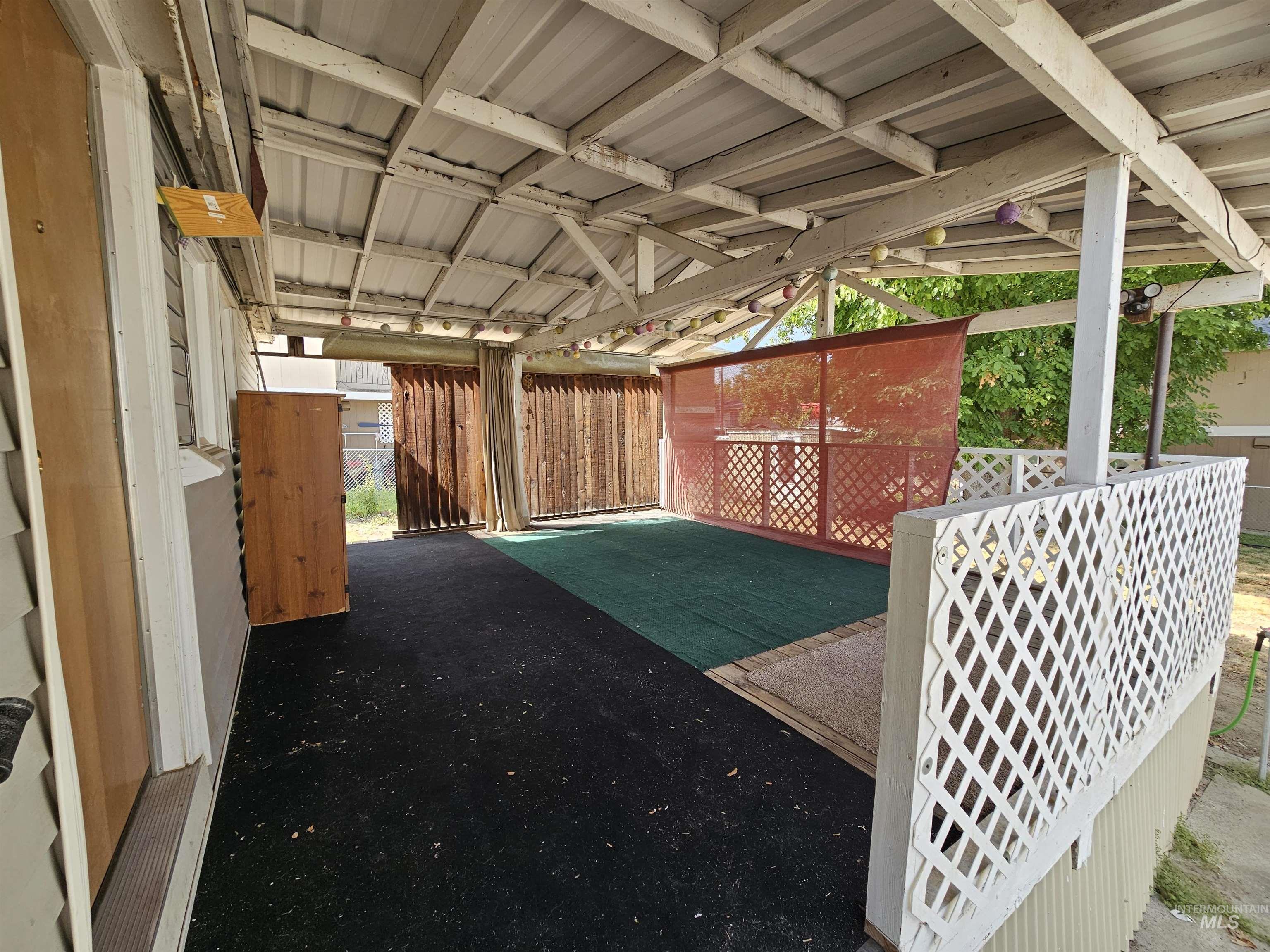 View of yard featuring an exterior structure, an outdoor structure, and a patio