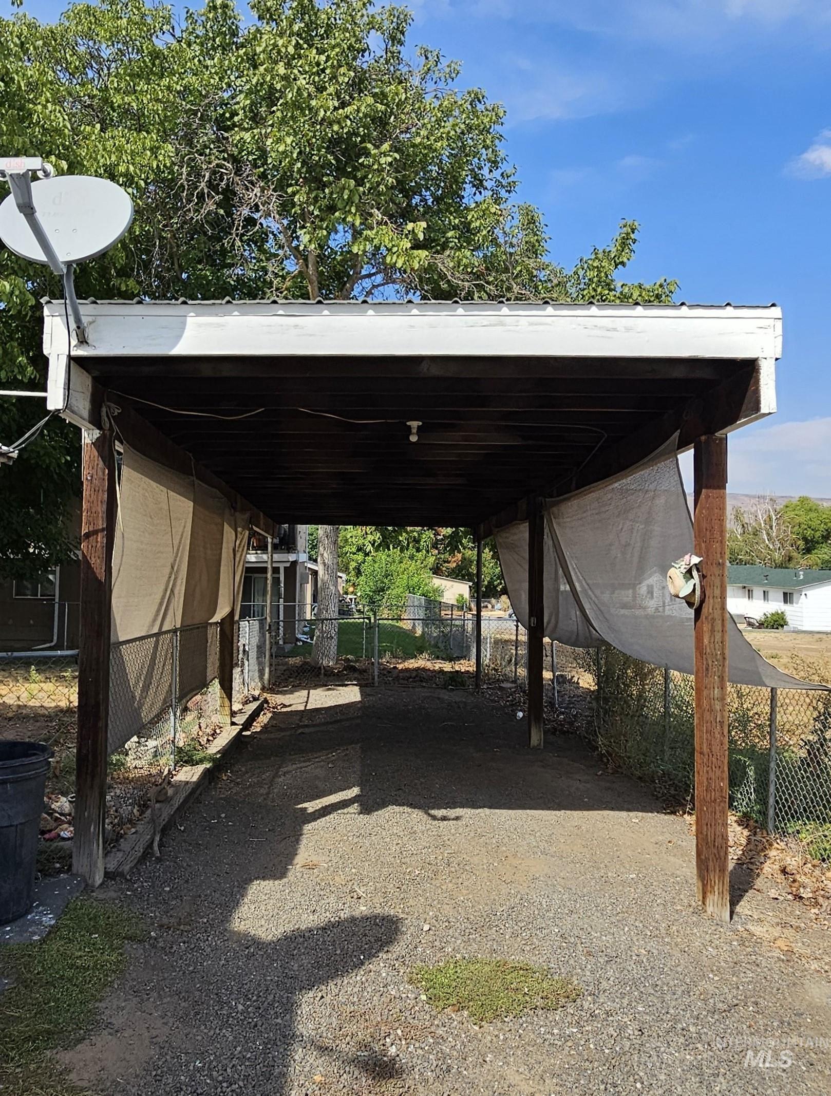 View of parking / parking lot with a carport