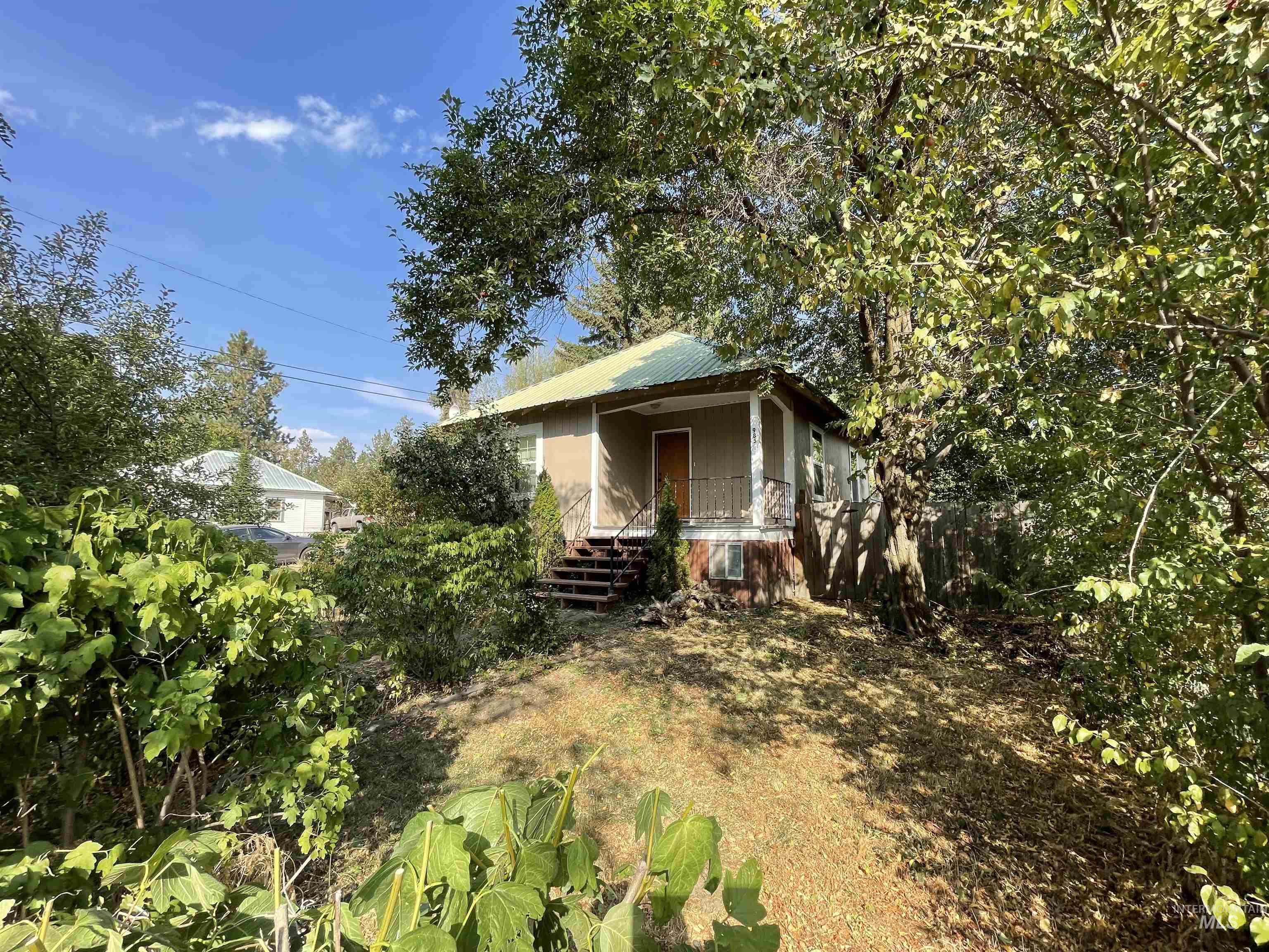 View of front of house with a metal roof and a porch