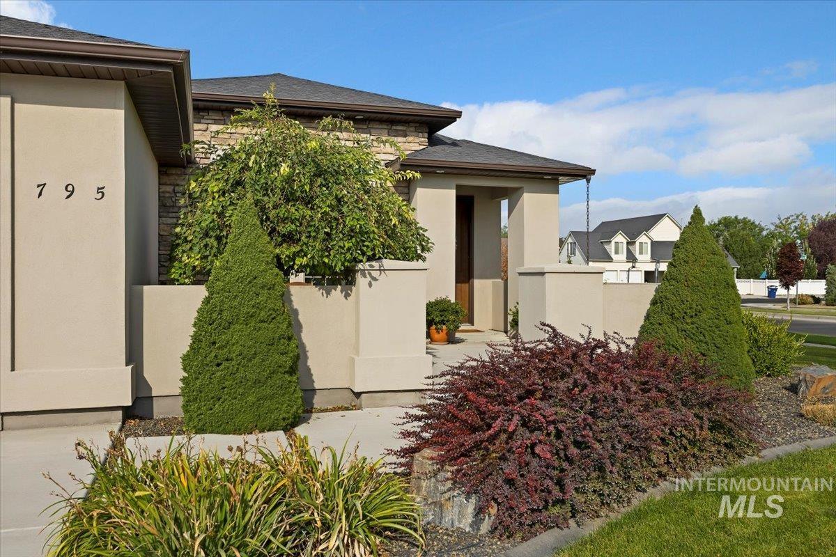 Doorway to property with stone siding and stucco siding