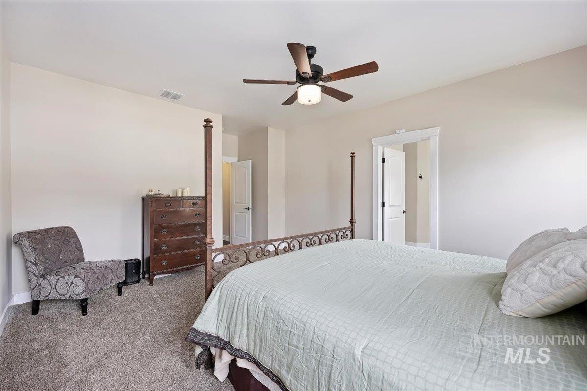 Bedroom with carpet floors and a ceiling fan