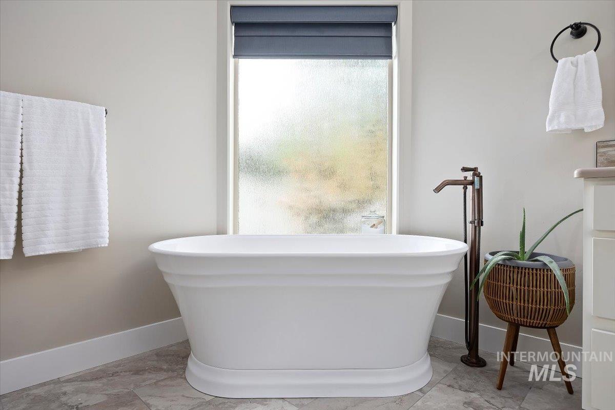 Full bath featuring a freestanding tub