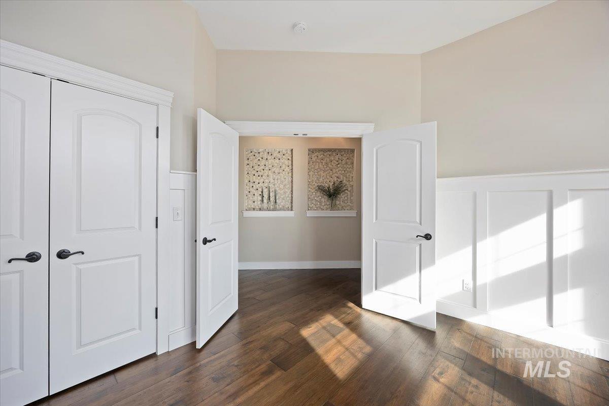 Bonus room featuring dark wood-style flooring