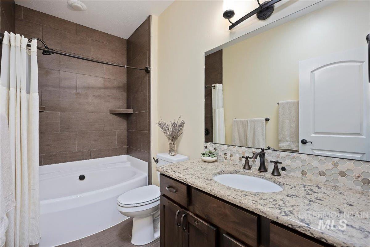 Full bathroom with vanity and shower / bath combo with shower curtain