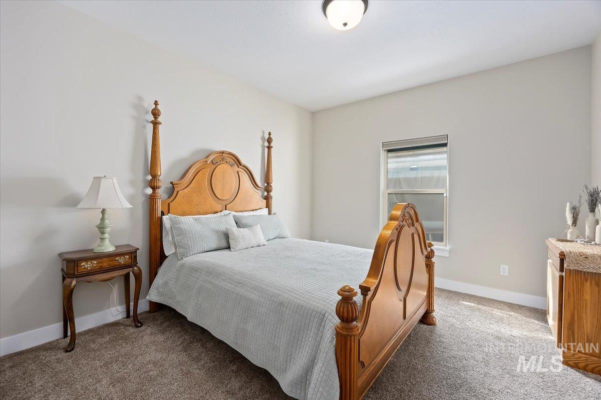 Carpeted bedroom with baseboards