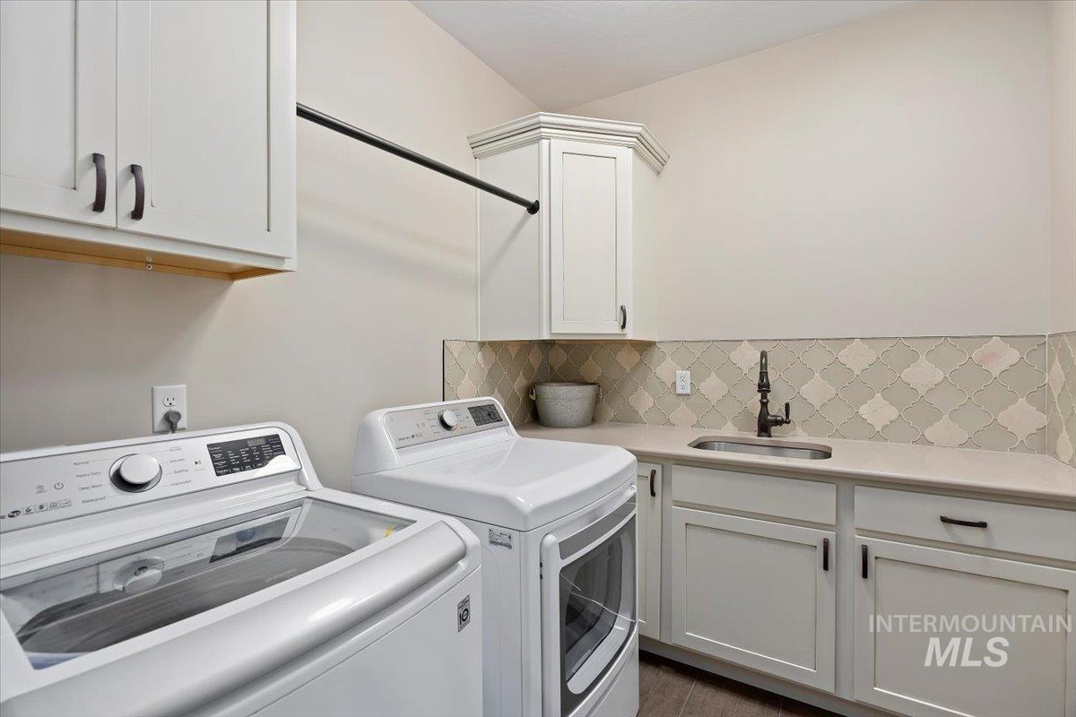 Laundry room featuring cabinet space and independent washer and dryer