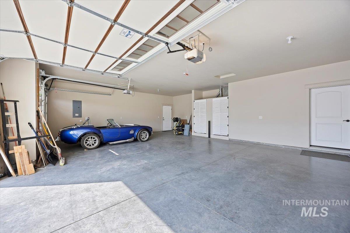 Garage with electric panel and a garage door opener