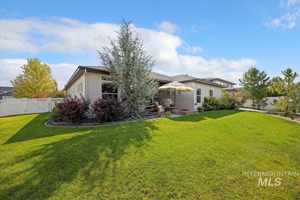 View of front of home with a fenced backyard and a patio area
