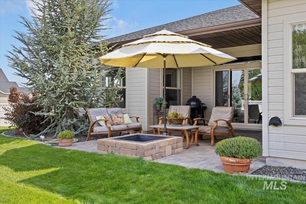 View of patio with a grill
