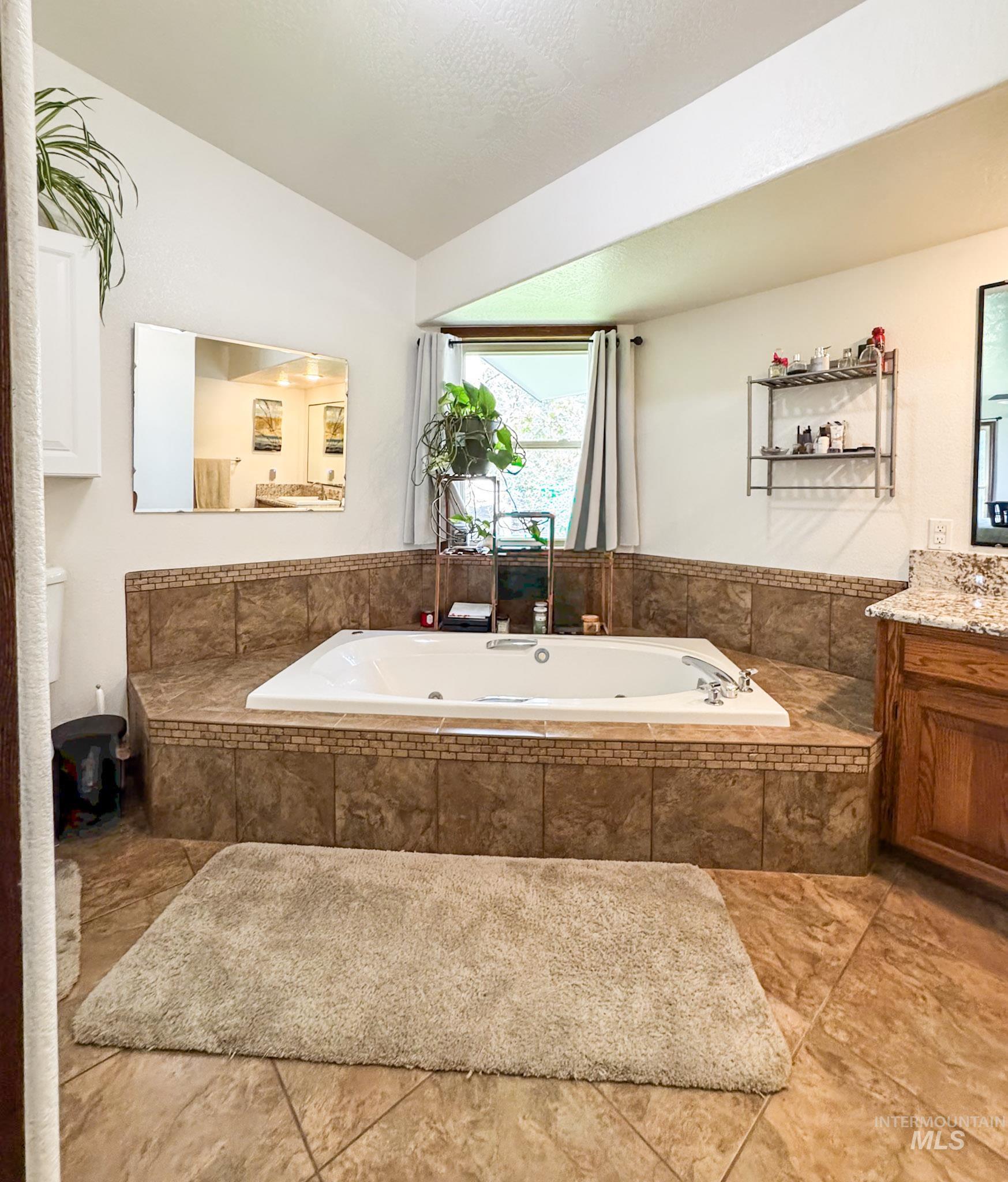 Bathroom with vanity and a garden tub