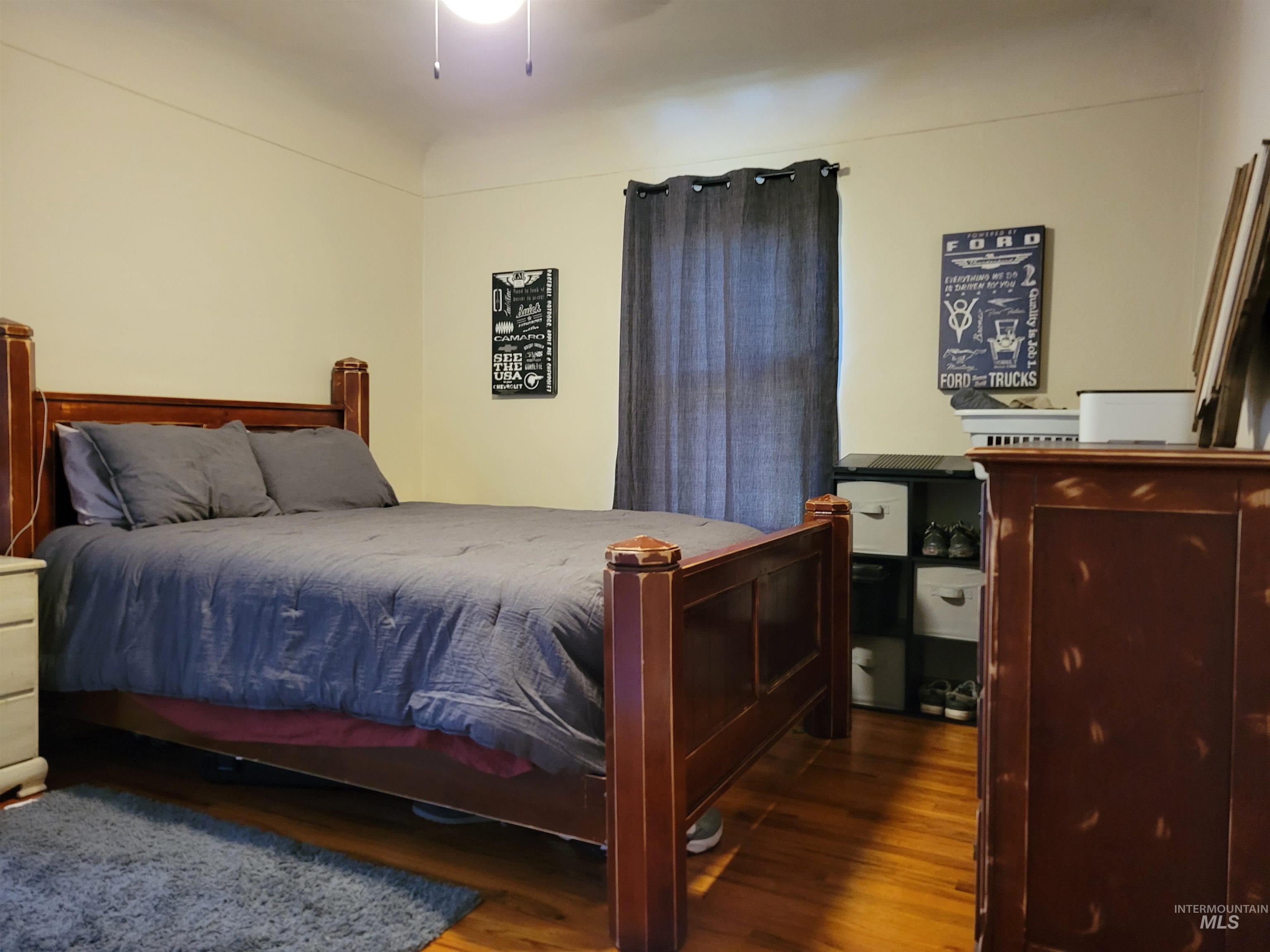 Bedroom with wood finished floors and a ceiling fan