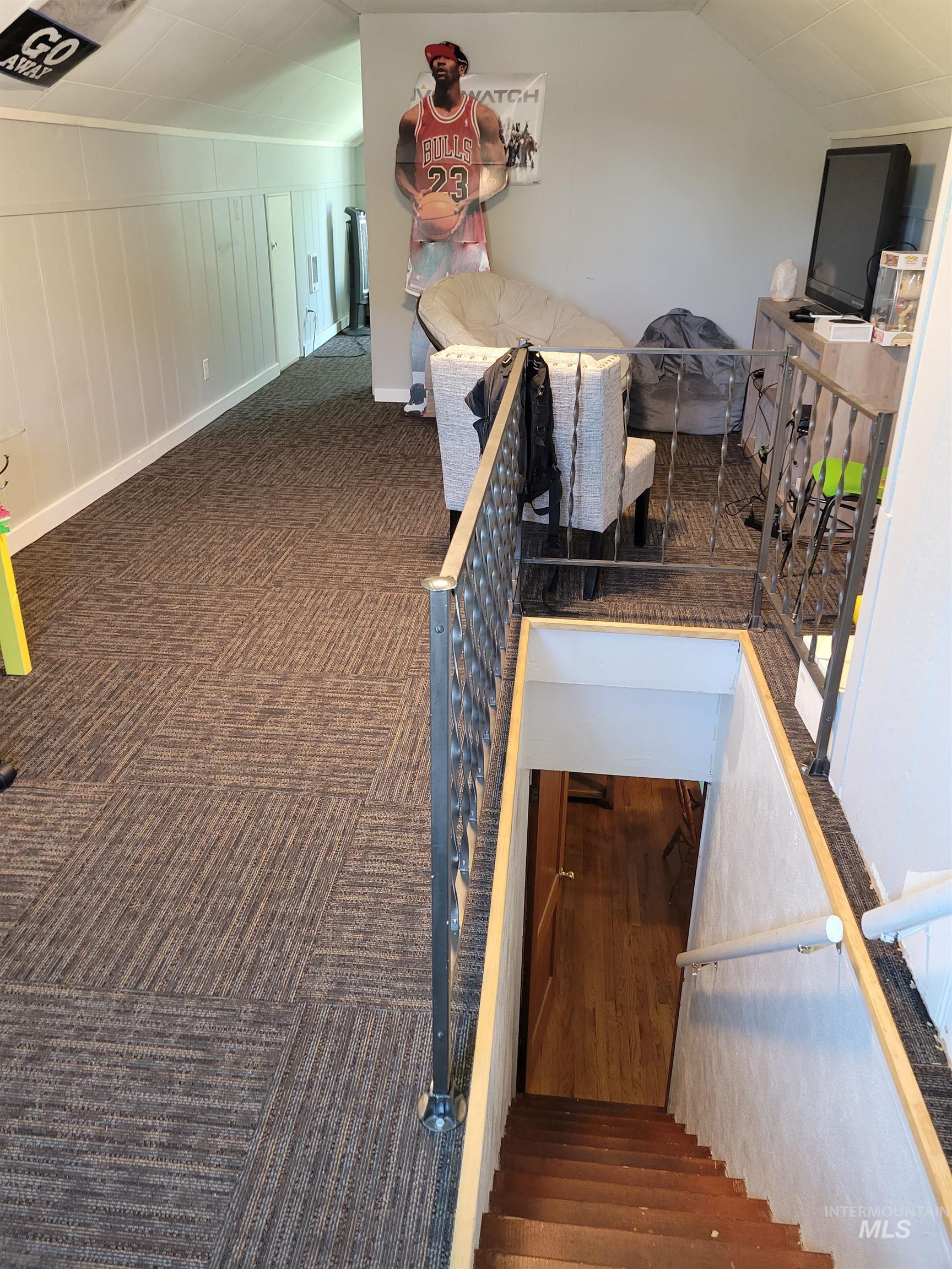Stairway featuring carpet and vaulted ceiling