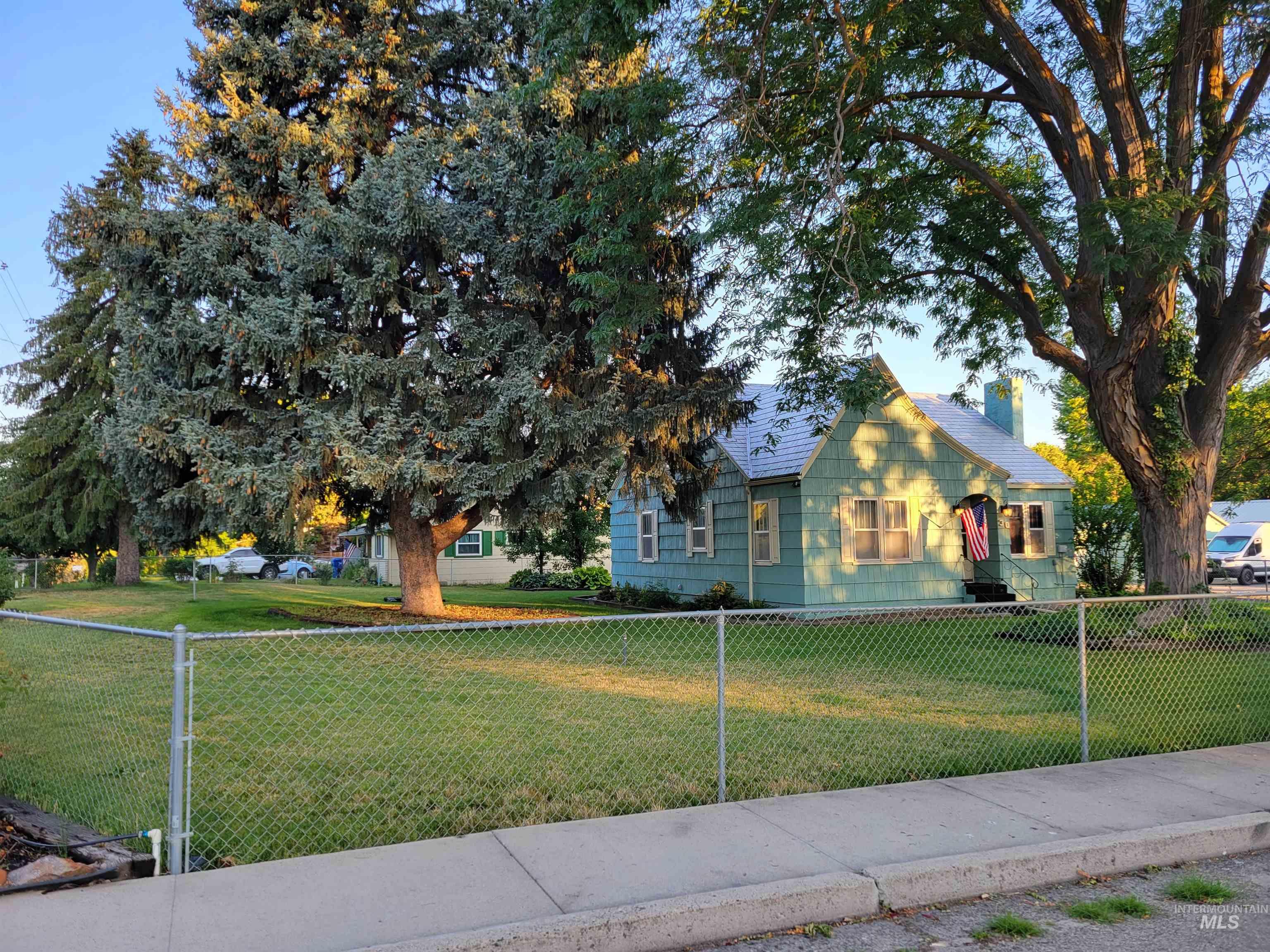 View of front of house featuring a fenced front yard and a chimney