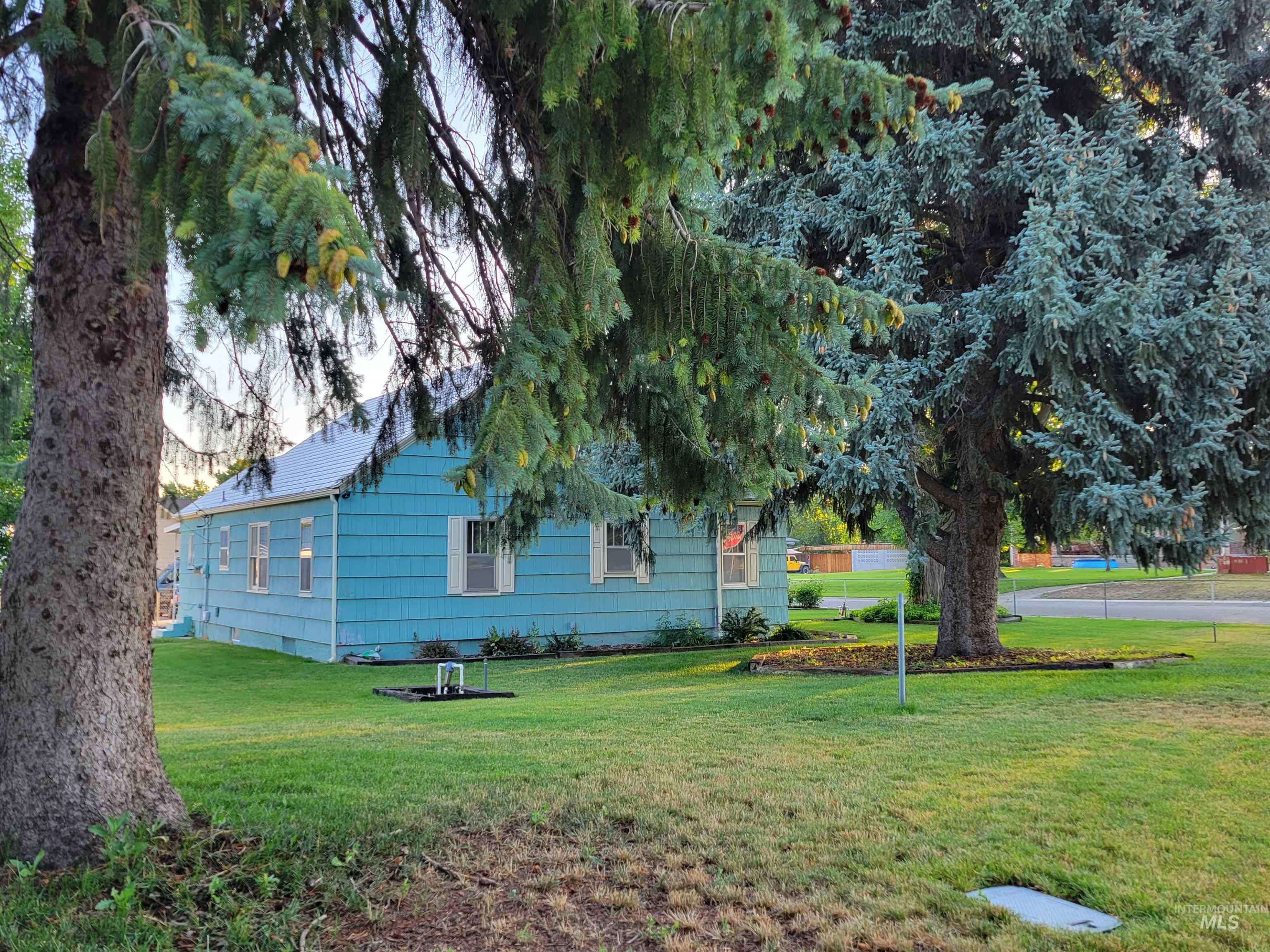 View of side of property with a lawn