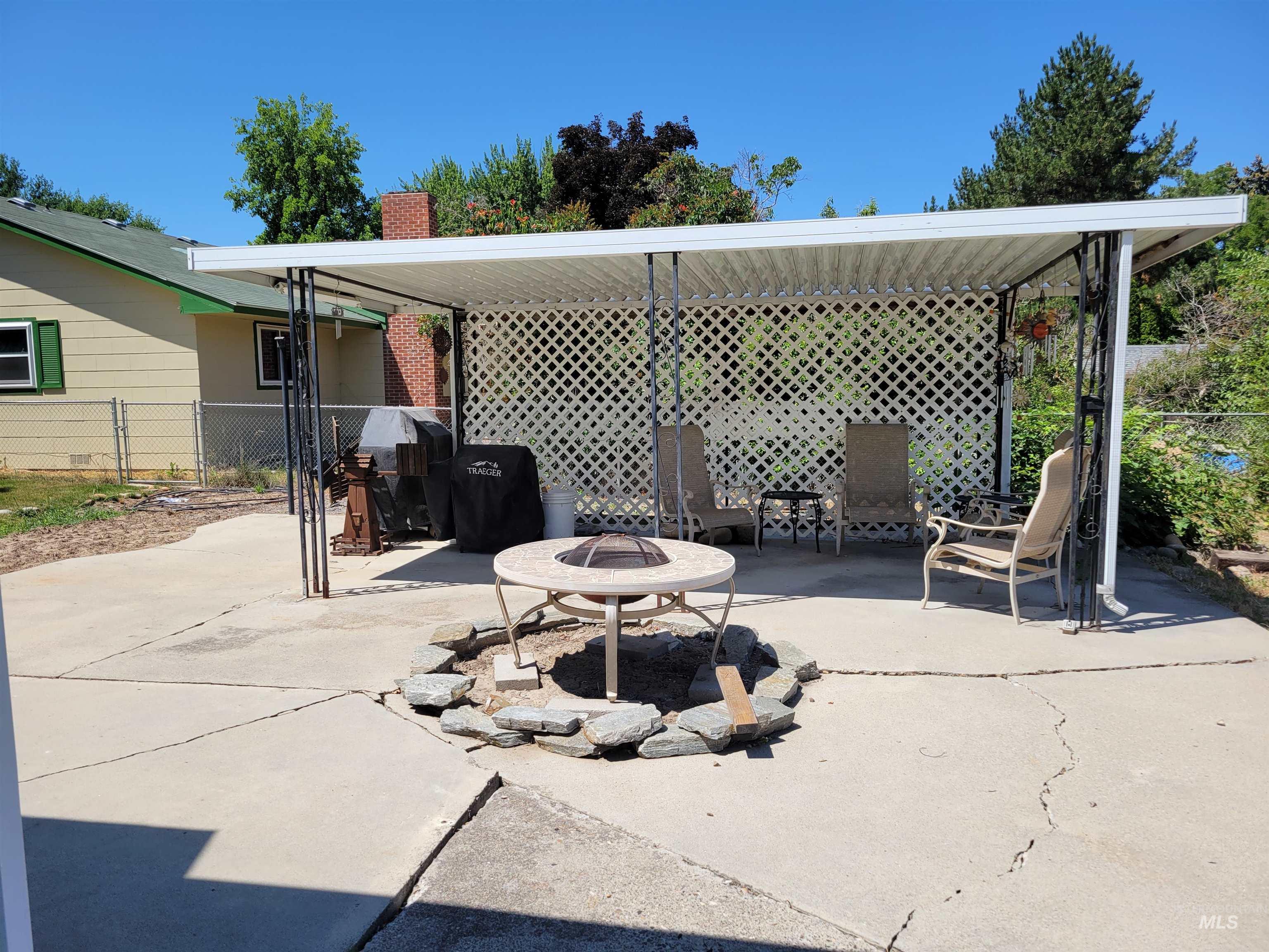 View of patio with an outdoor fire pit