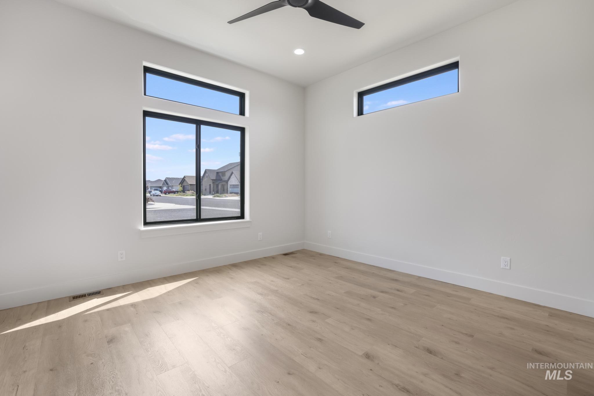 Empty room featuring light wood-style floors, recessed lighting, and ceiling fan