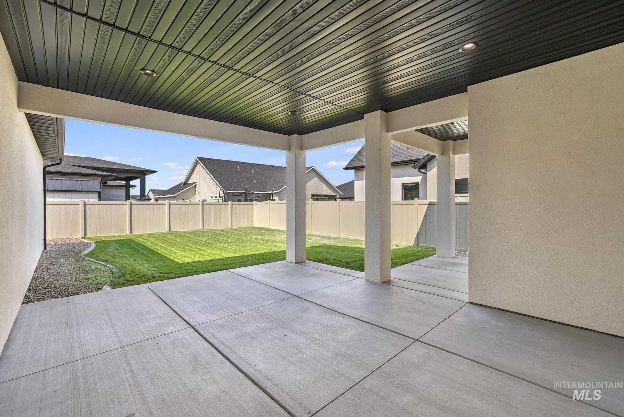 Fenced backyard with a patio