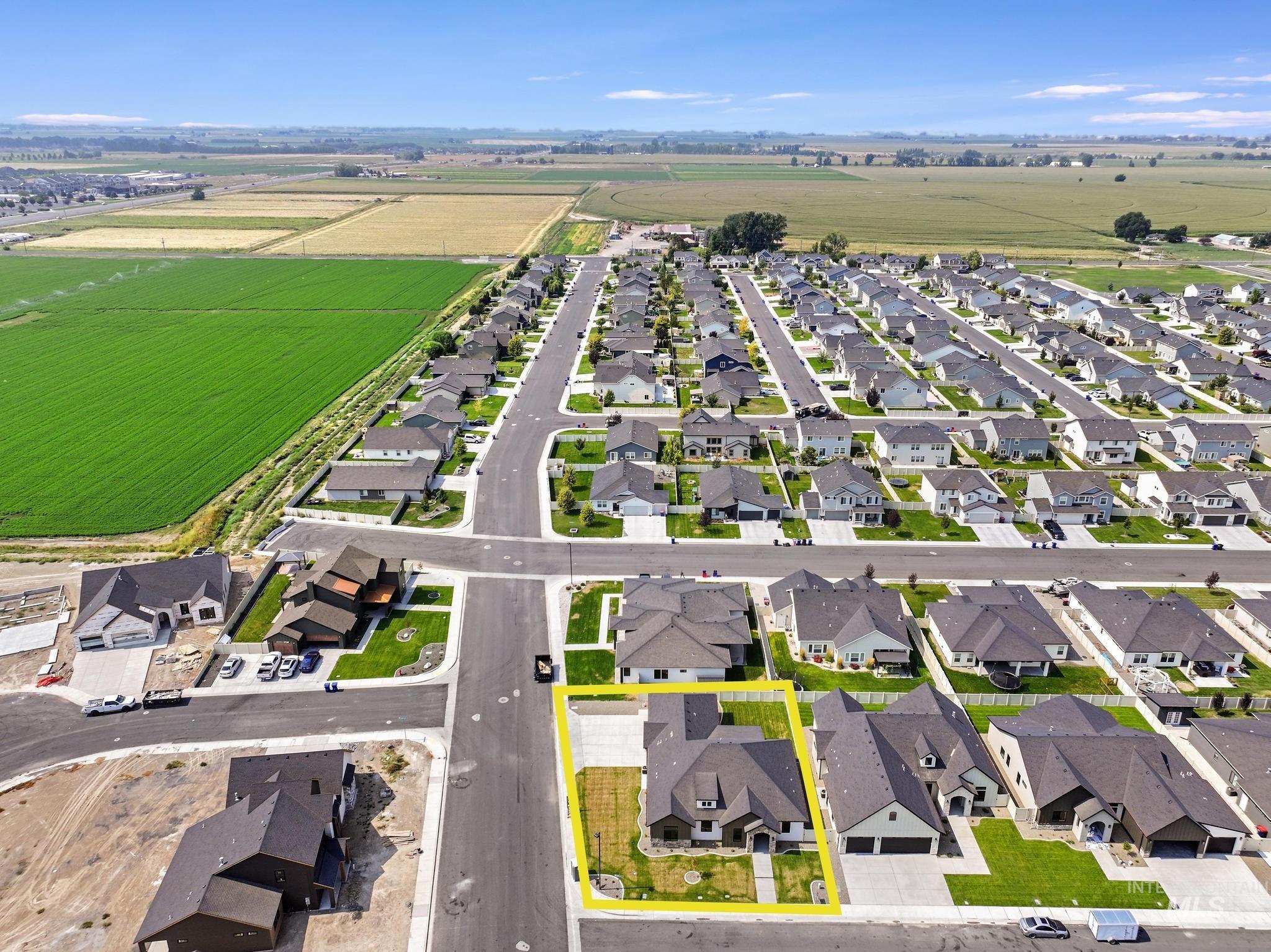 Aerial overview of property's location with property parcel outlined and nearby suburban area