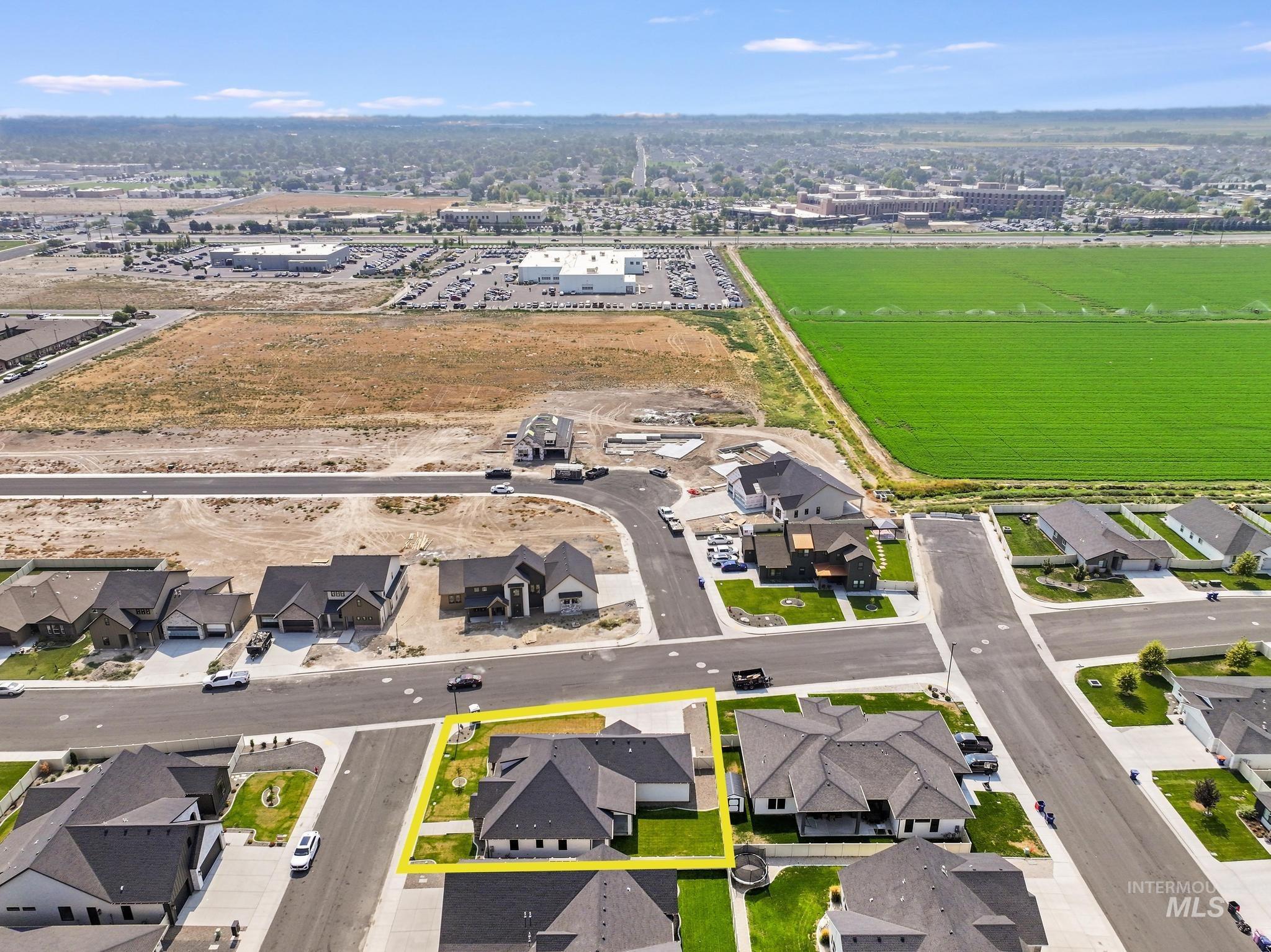 Aerial overview of property's location with property boundaries highlighted and nearby suburban area