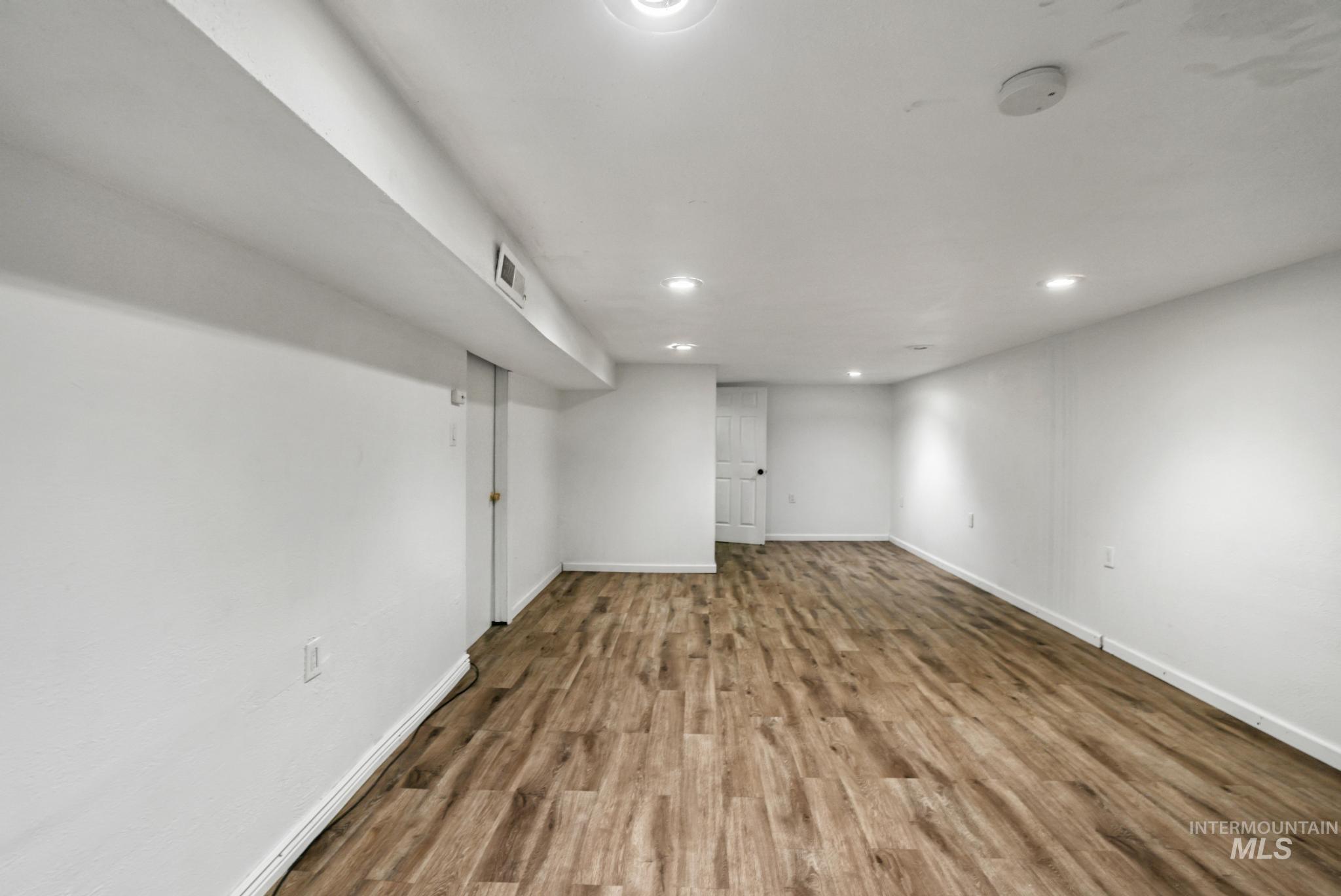 Finished basement featuring wood finished floors and recessed lighting