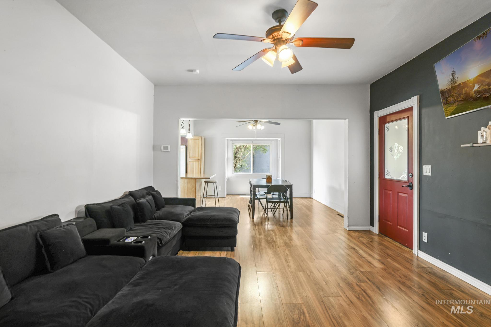 Living area featuring wood finished floors and a ceiling fan