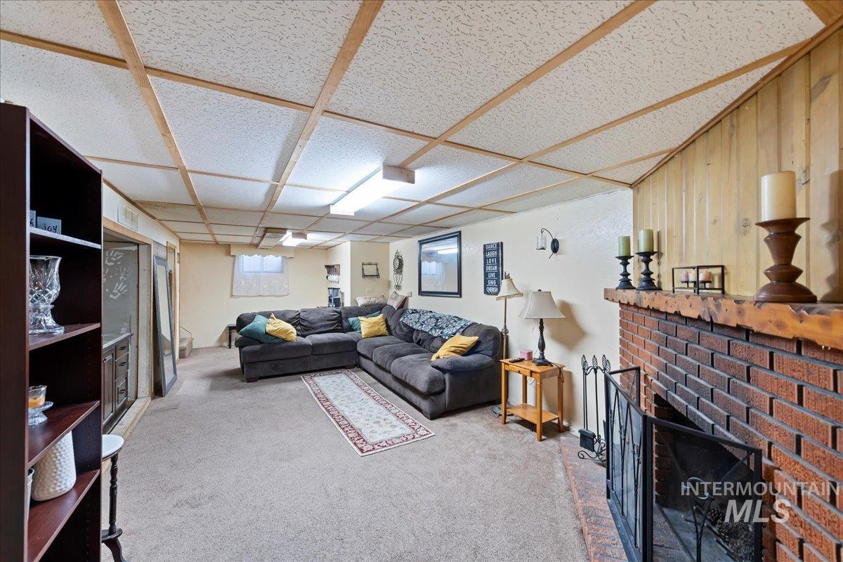 Carpeted living room with a fireplace