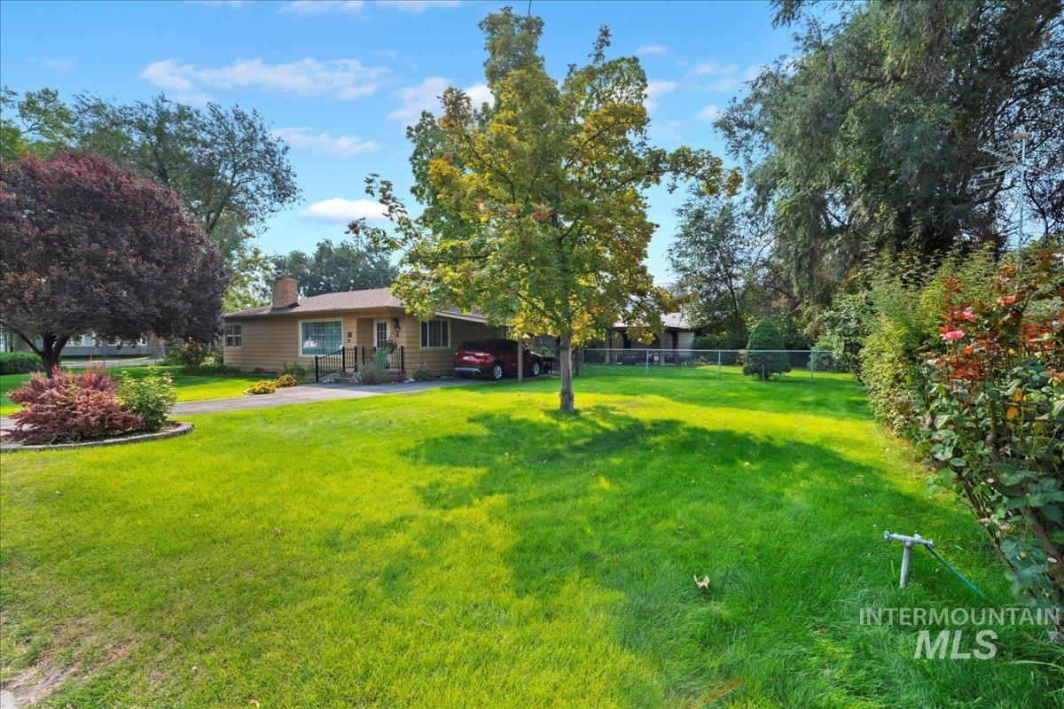 View of yard featuring an attached carport and driveway