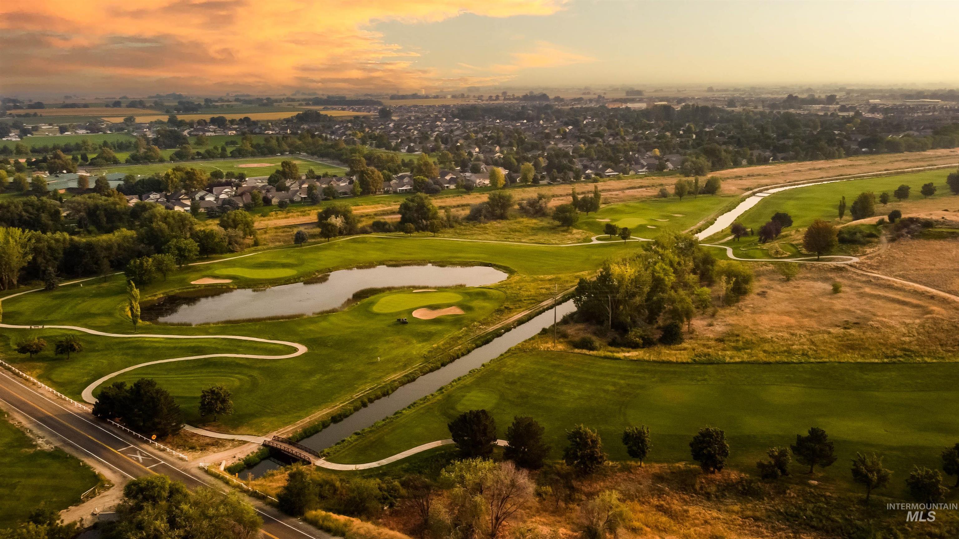 Aerial view at dusk of a water view and golf course view