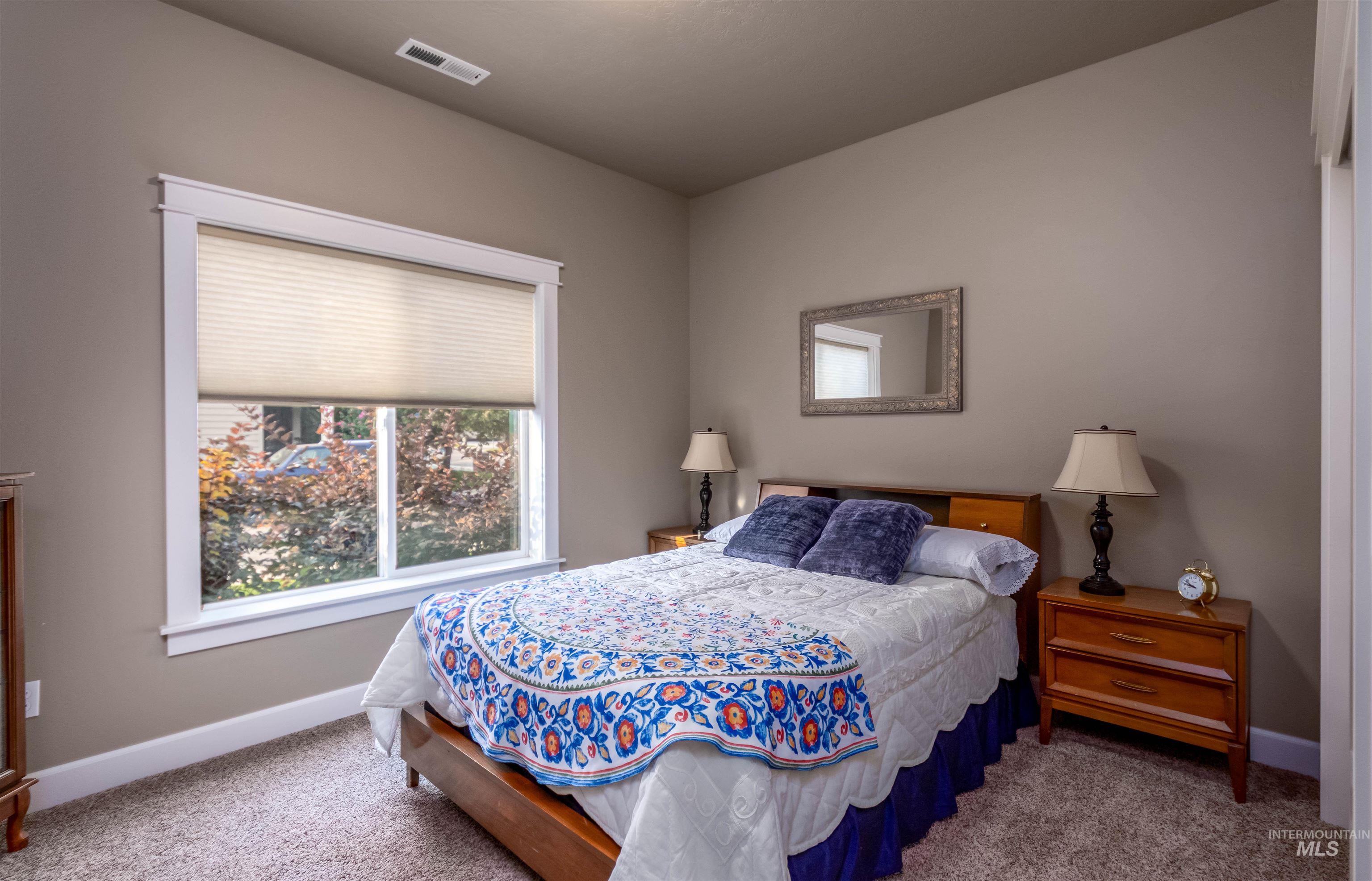 Bedroom featuring carpet flooring and baseboards