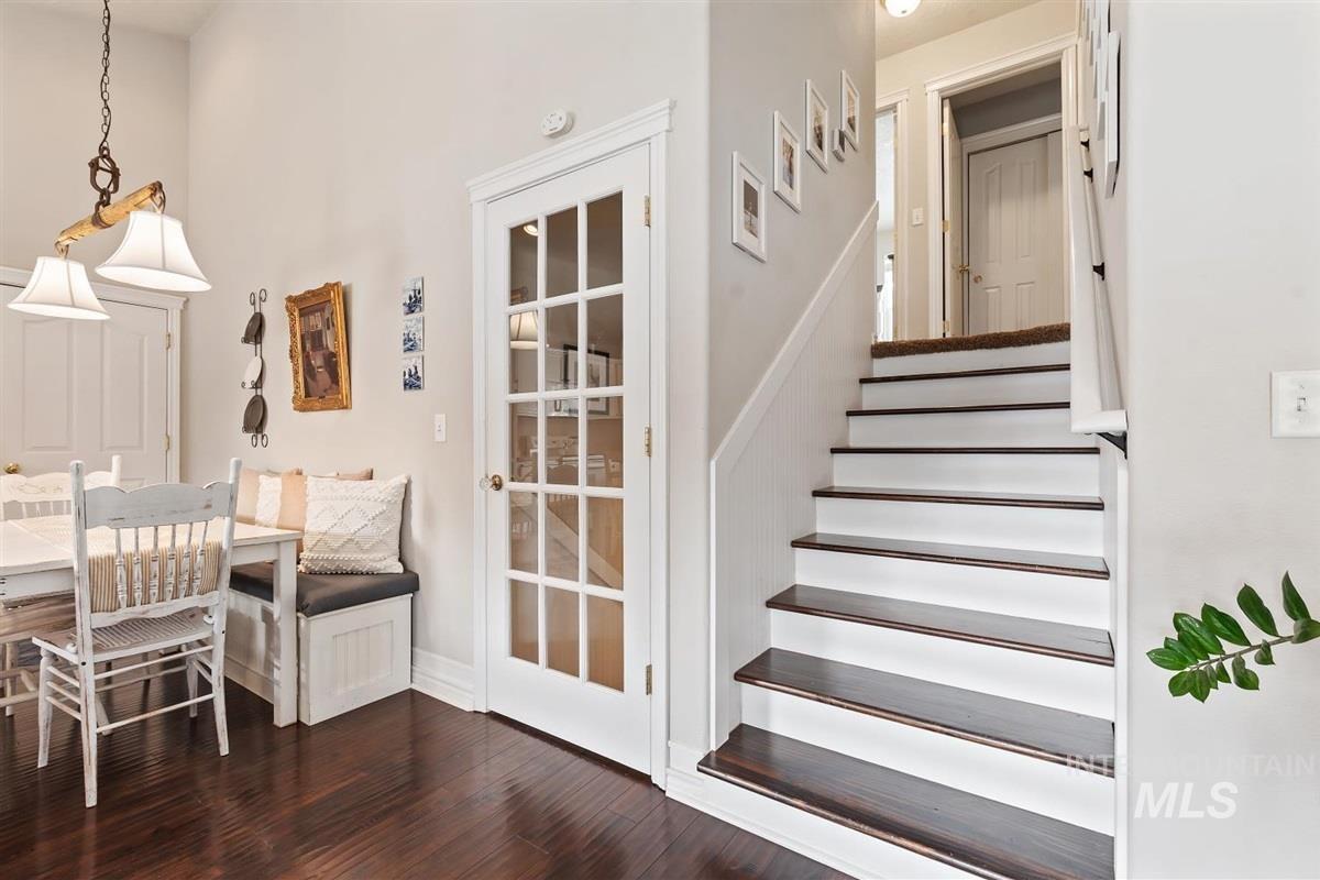 Stairway featuring wood finished floors and baseboards
