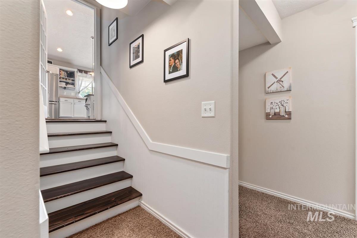 Staircase featuring carpet and baseboards