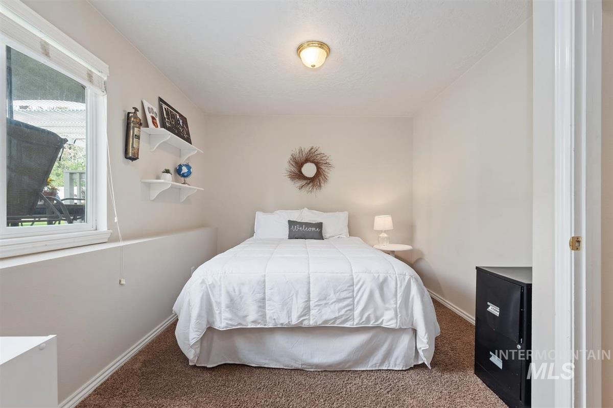 Bedroom featuring carpet floors and baseboards