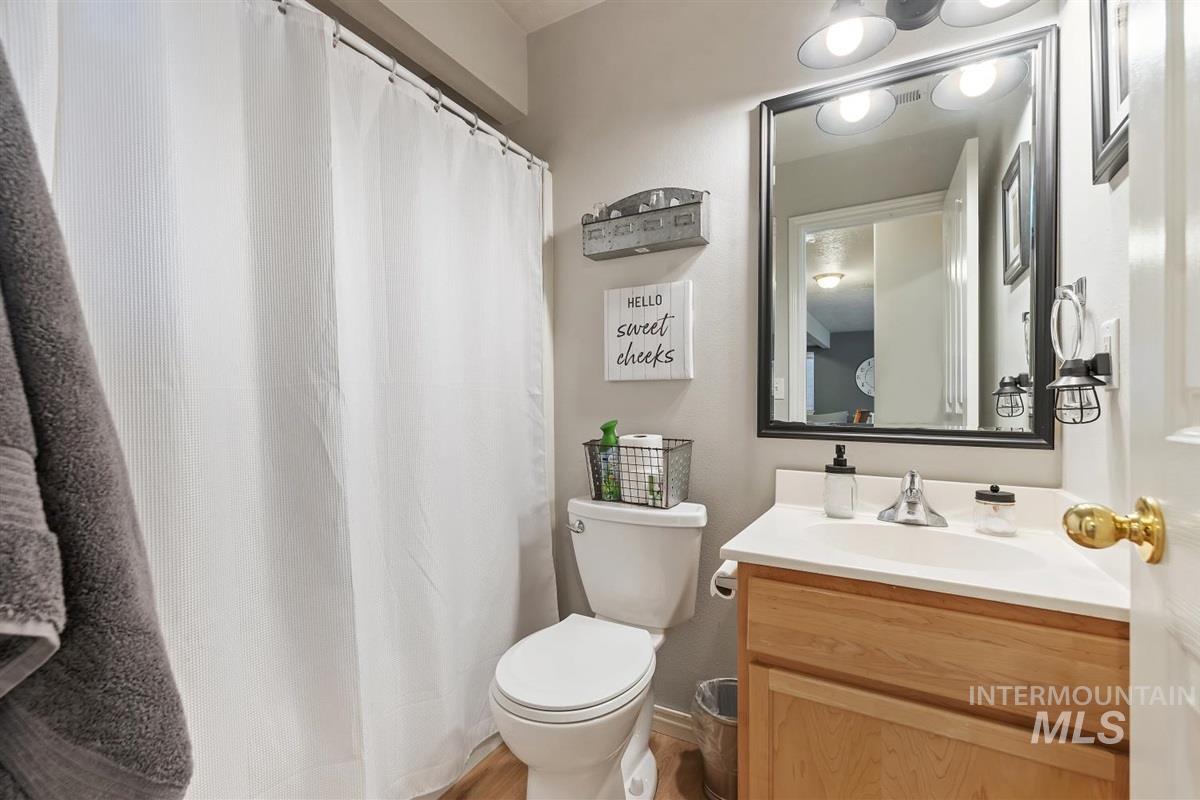 Full bath with vanity and a shower with curtain