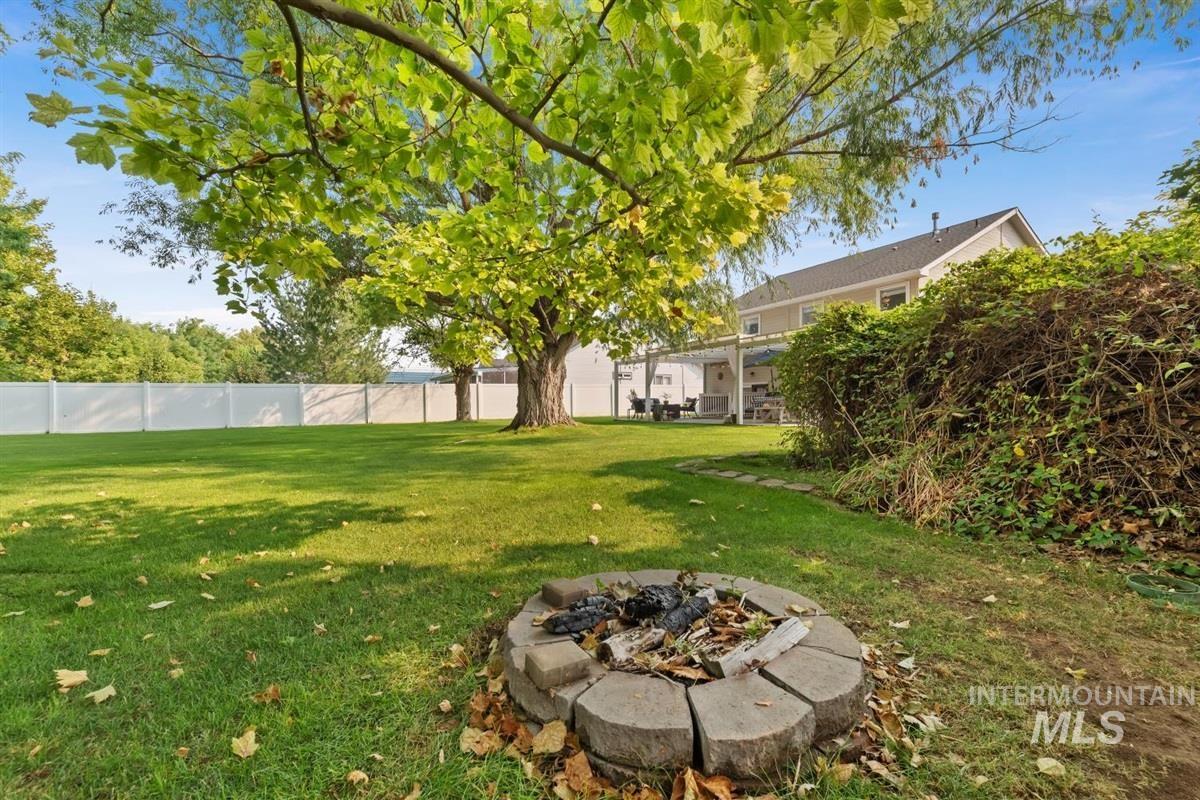 View of yard featuring a patio and a fire pit