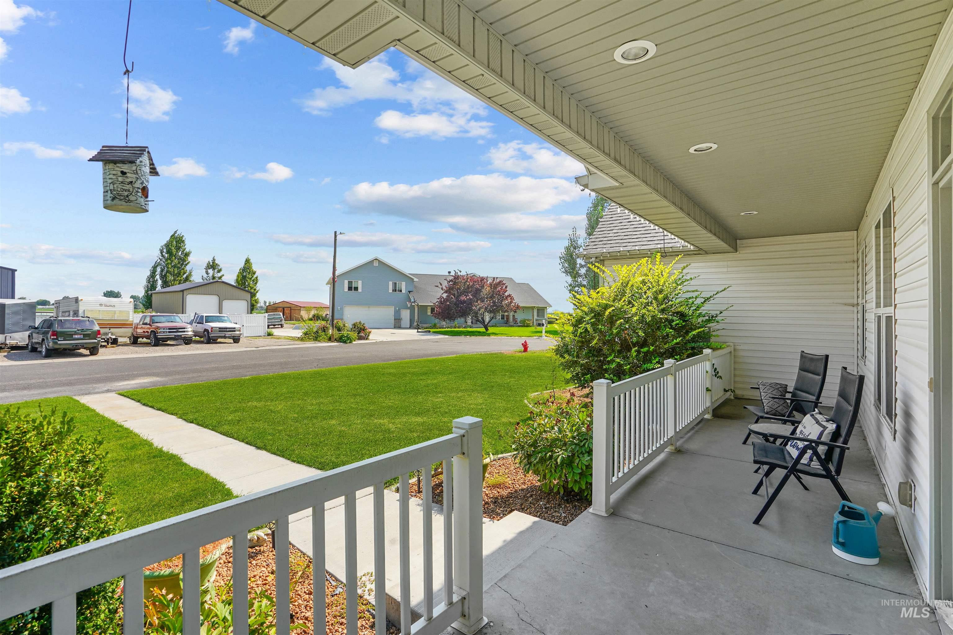 Porch with a residential view and a yard