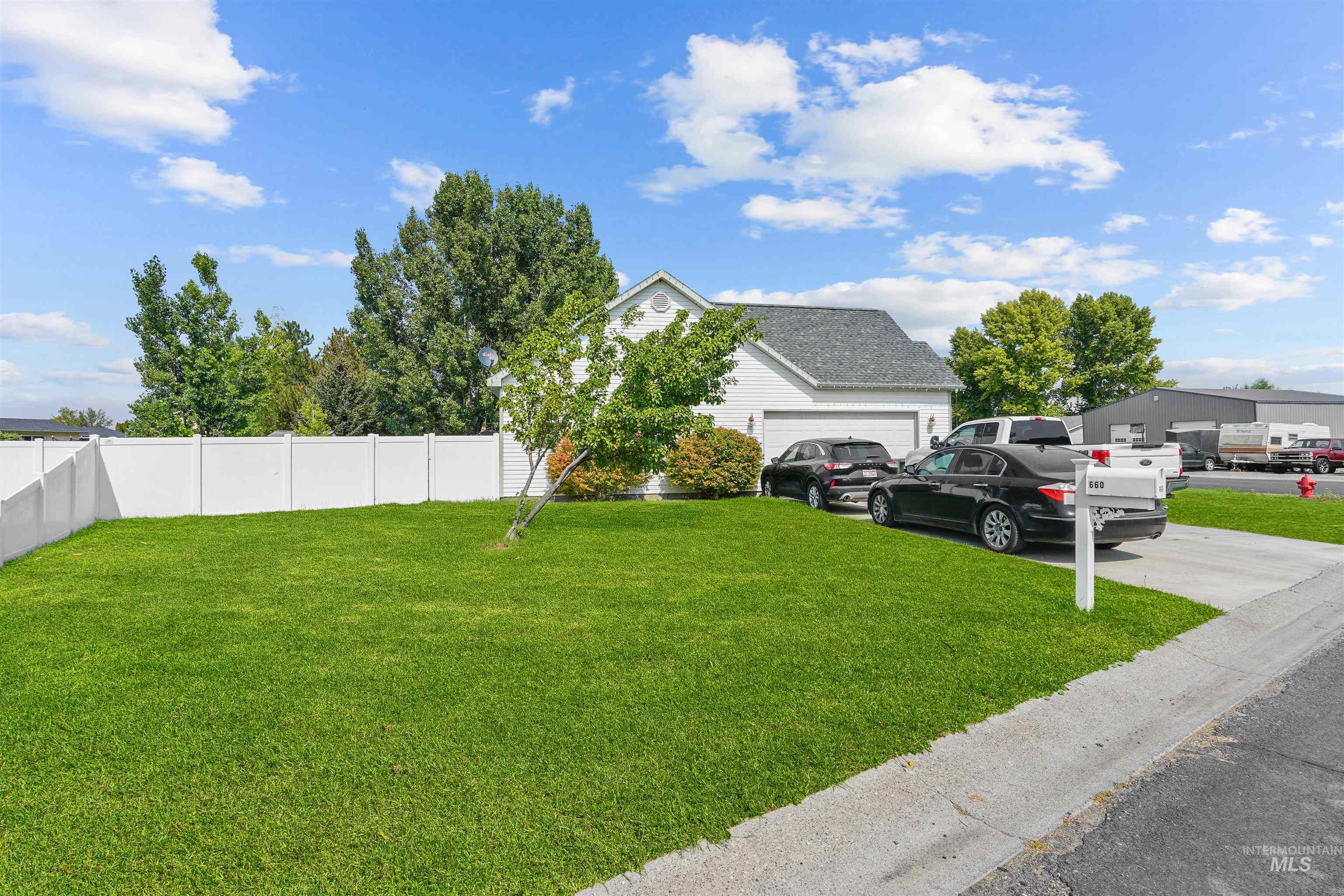 View of yard with driveway and an attached garage