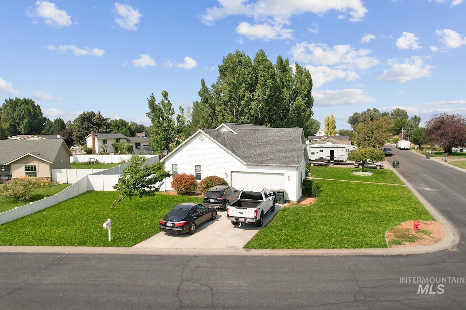 View of front of home with concrete driveway, a residential view, and a garage
