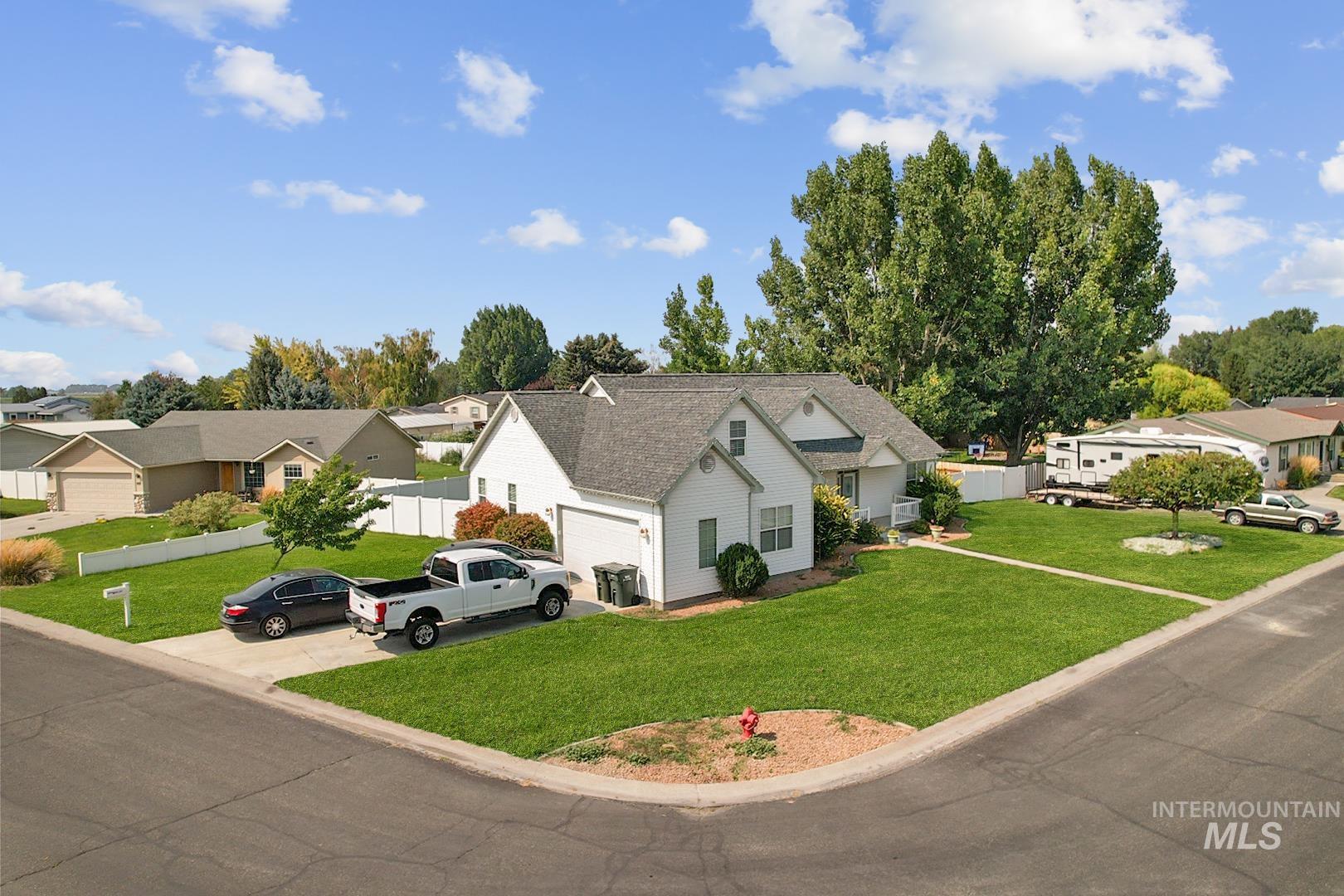 View of front of house featuring a residential view, concrete driveway, and an attached garage