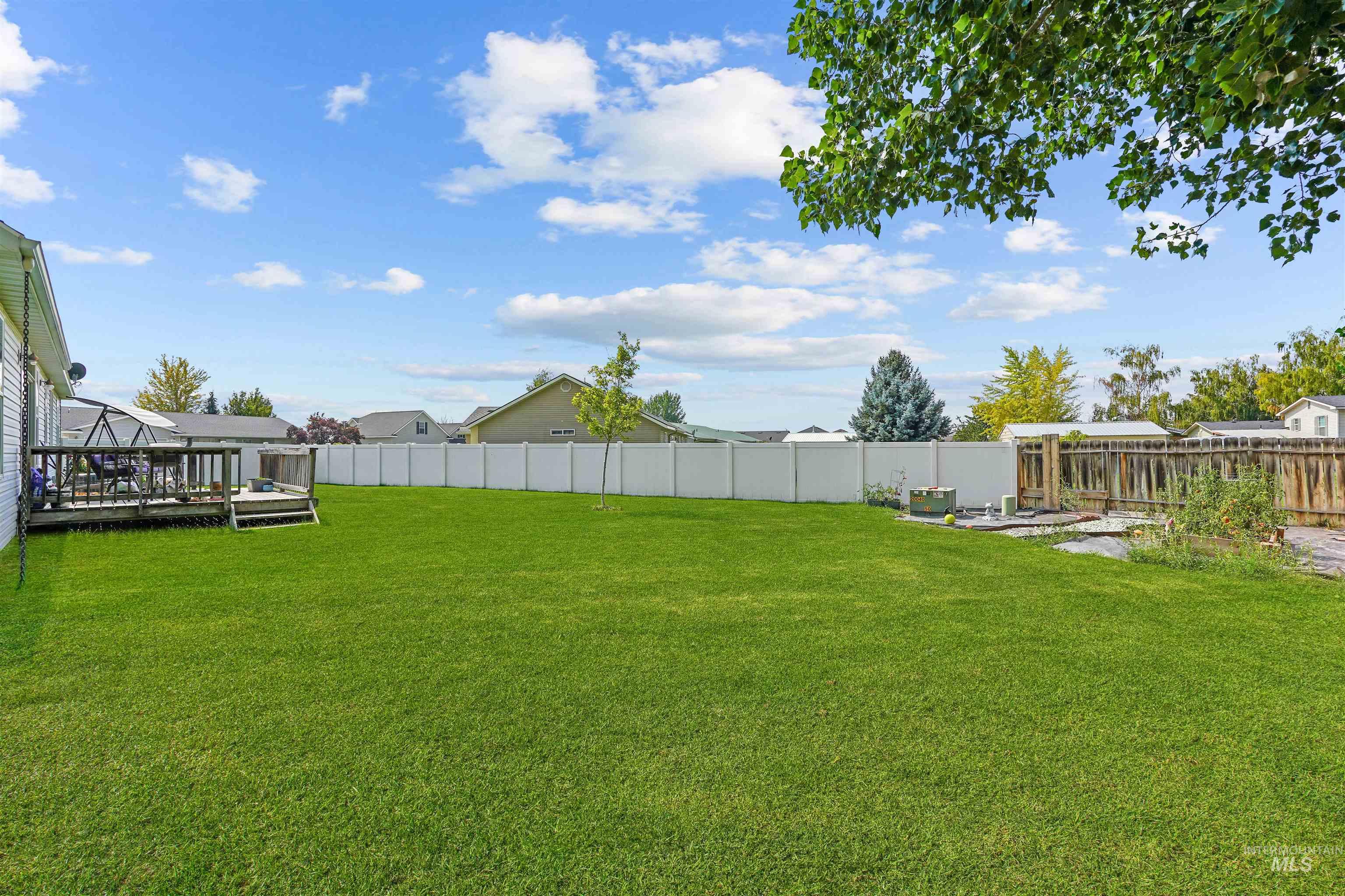 Fenced backyard featuring a wooden deck