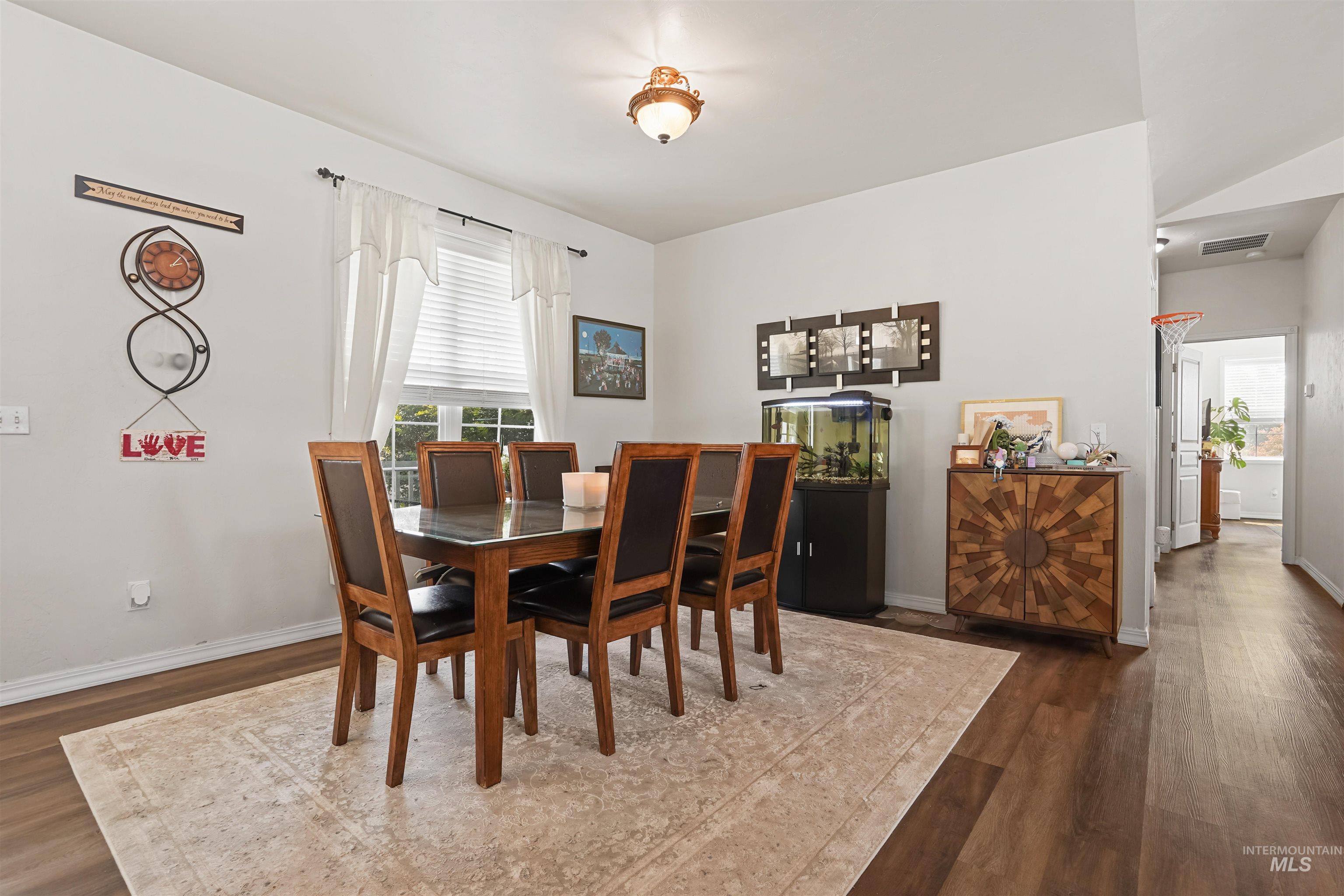 Dining area with dark wood finished floors and baseboards