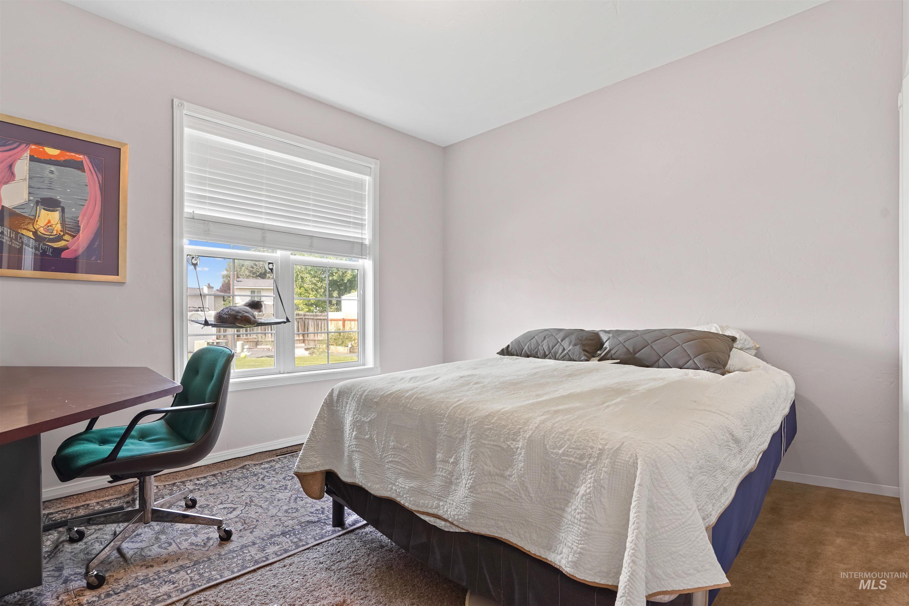 Carpeted bedroom with baseboards