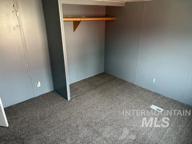 Unfurnished bedroom featuring carpet flooring and a closet