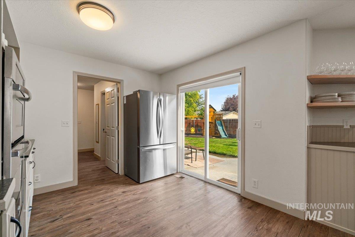 Kitchen featuring appliances with stainless steel finishes and light wood-style flooring